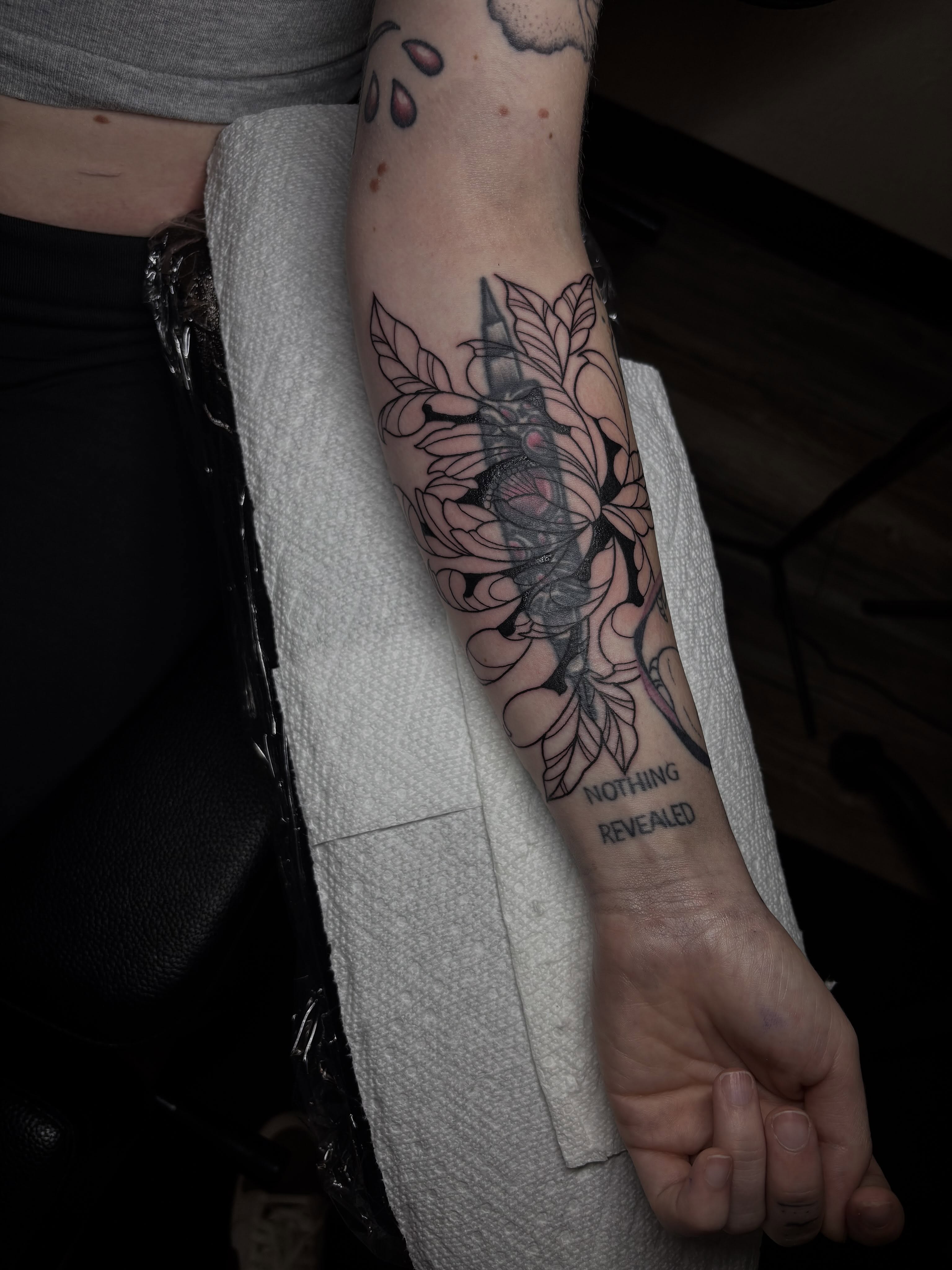 Flower with skull black and grey tattoo on the forearm by Grace L