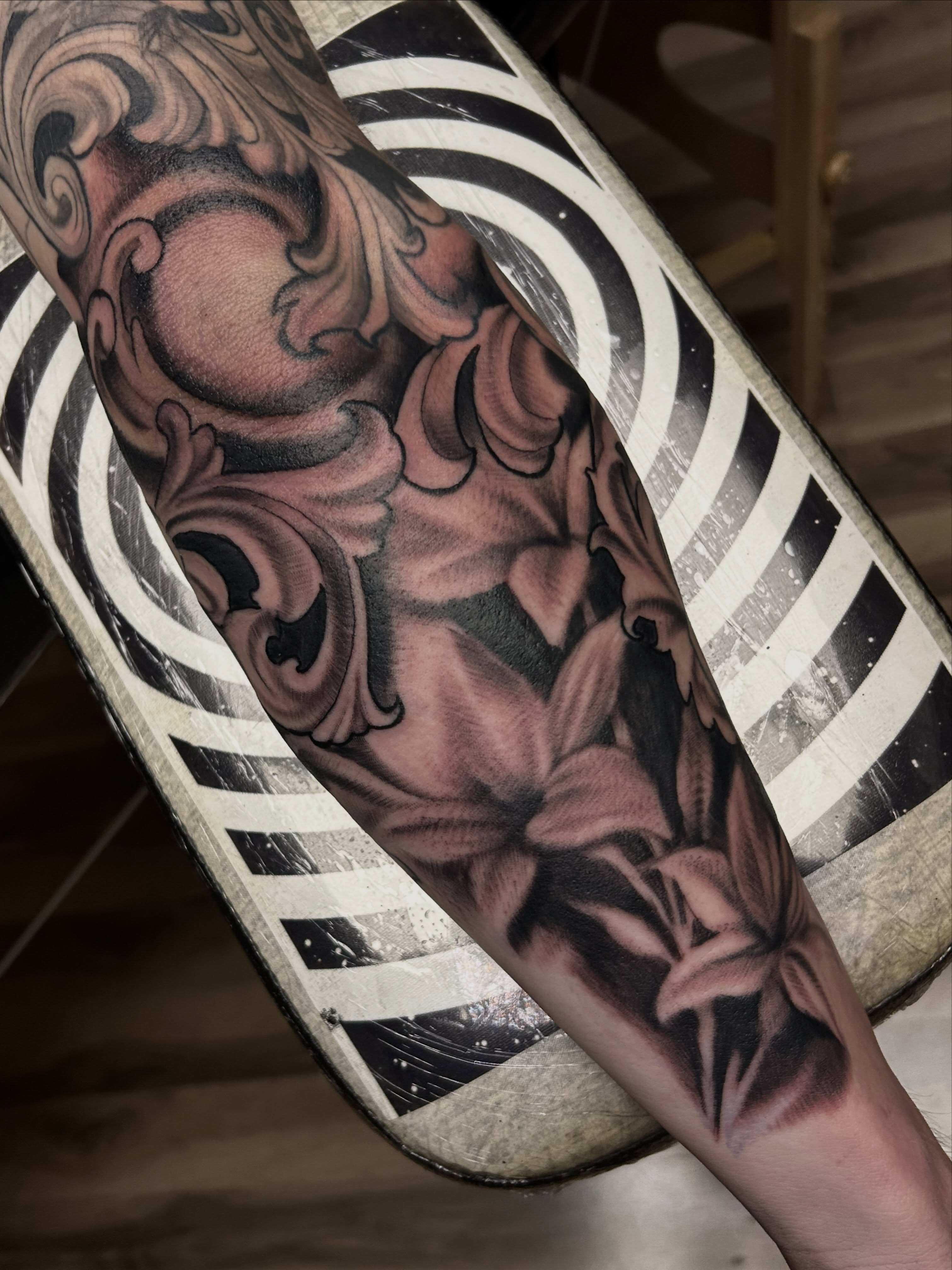 Floral bouquet realism tattoo on the forearm by Dan Schuster