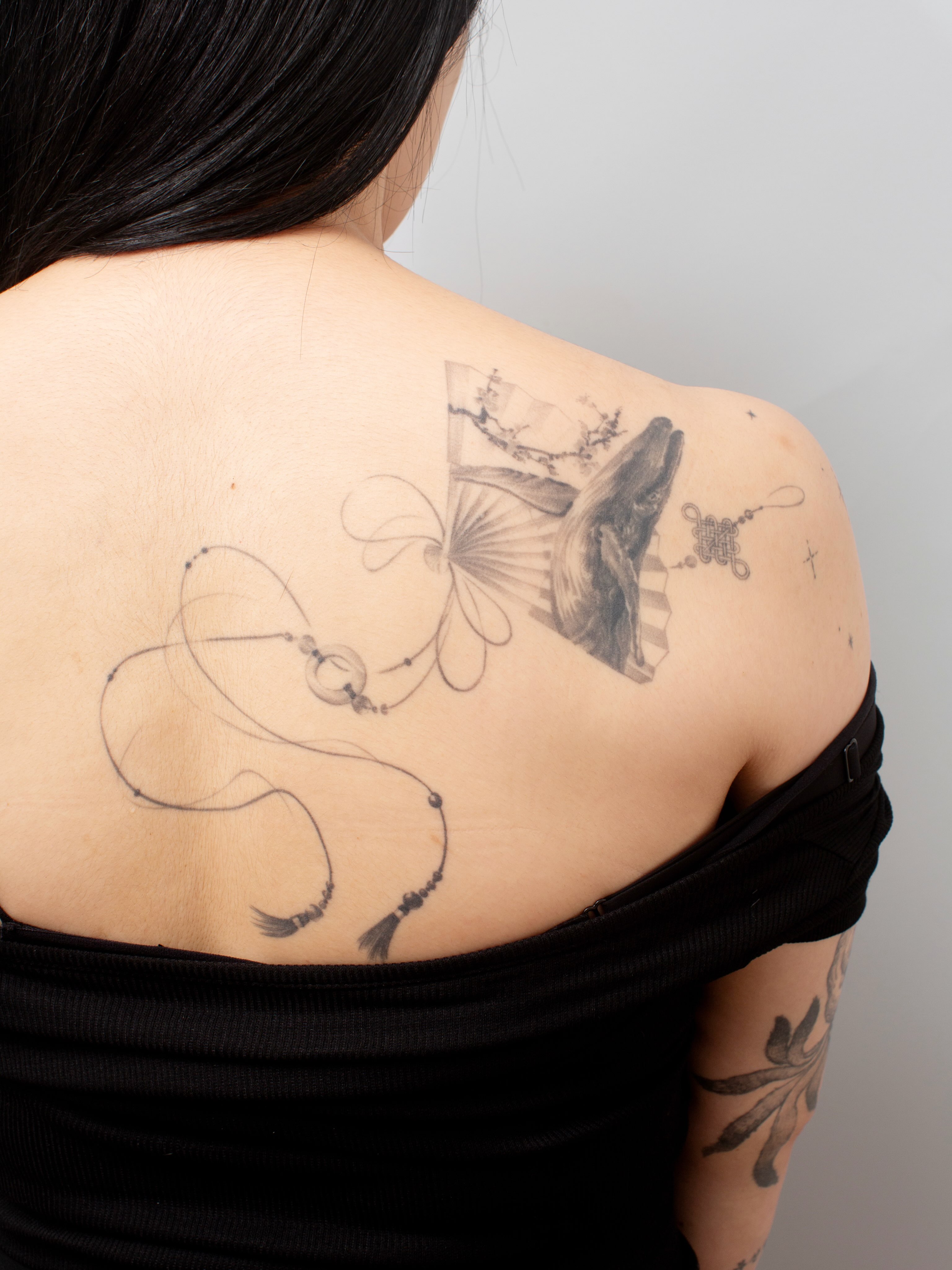 Whale and fan black and grey tattoo on the shoulder by Taeyeon▪️Tattoos are literature🇰🇷