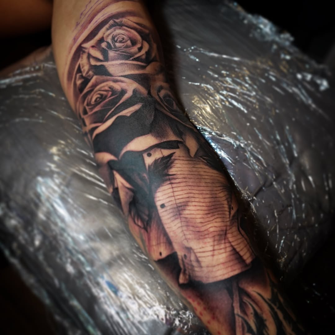 Roses and textured fabric realism tattoo on the forearm by Erick Satchell II