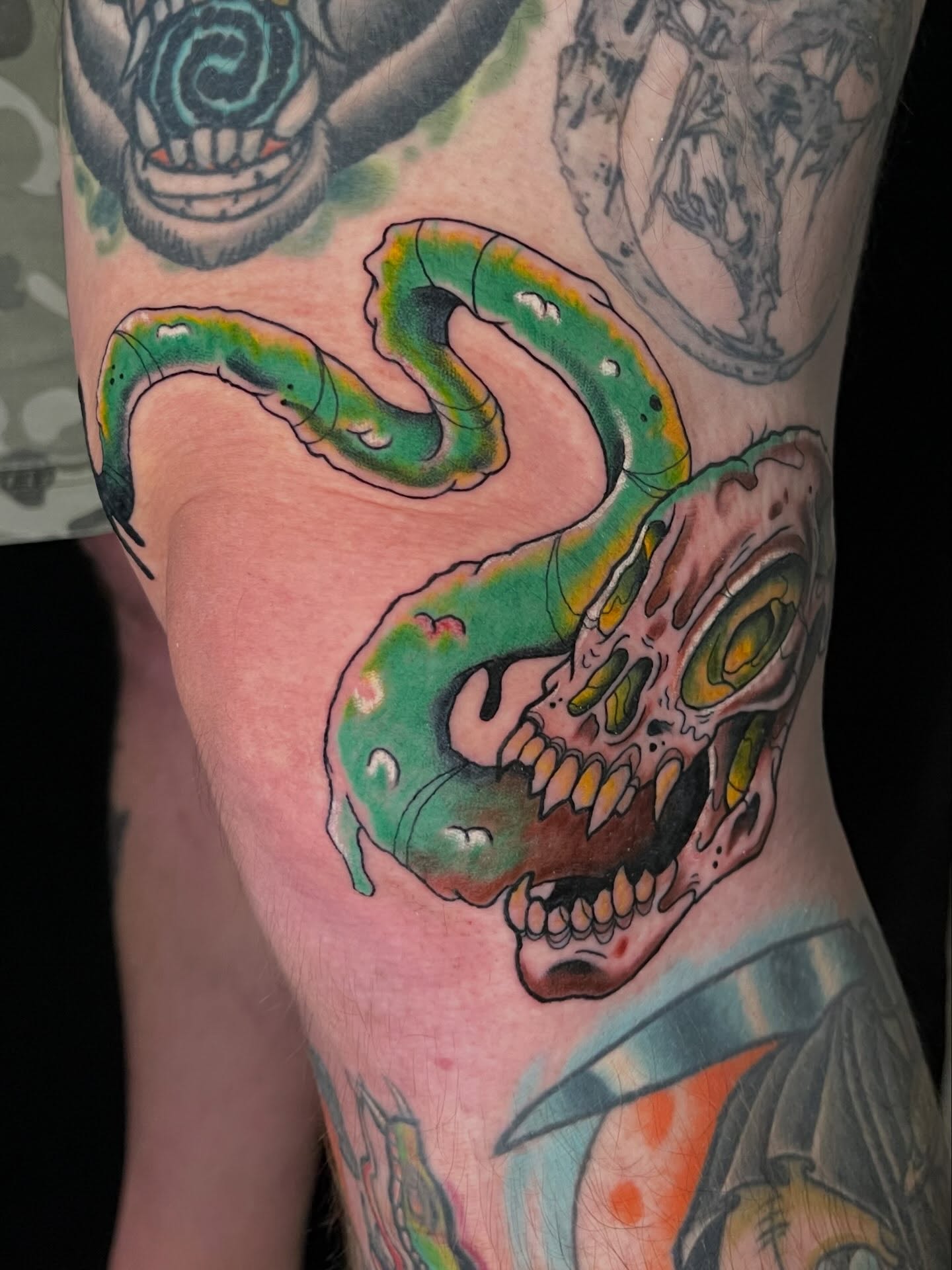 Snake skull new school tattoo on the forearm by Josh Brownell