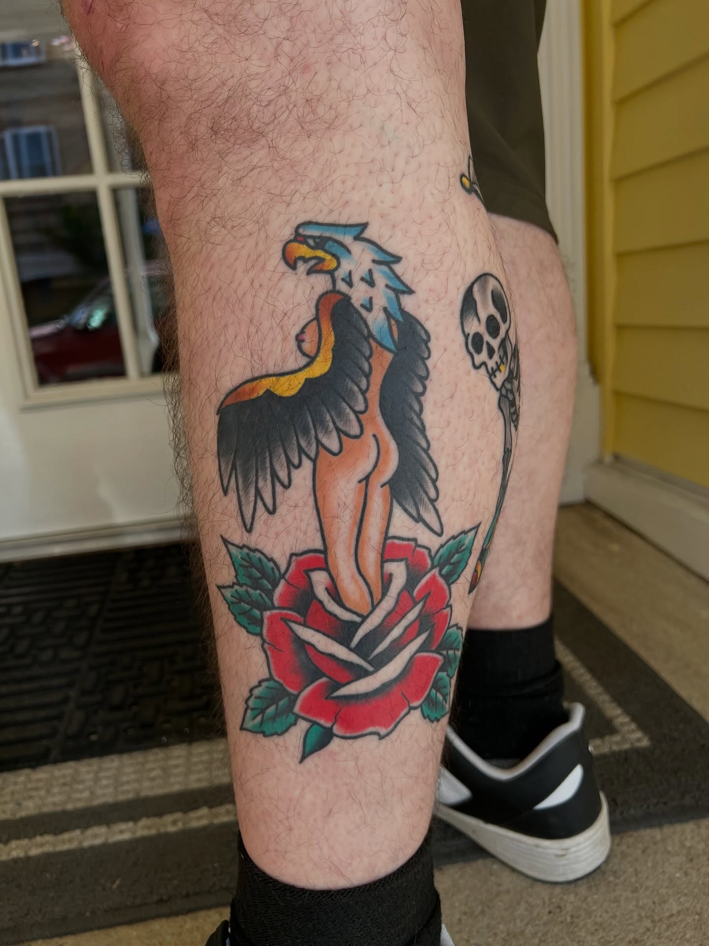 Woman with eagle and rose American traditional tattoo on the thigh by Tyler Van Pelt