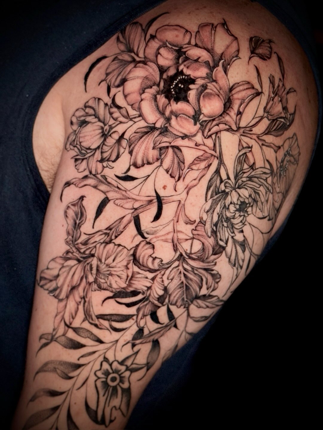 Floral bouquet black and grey tattoo on the shoulder by Giovanna Kline