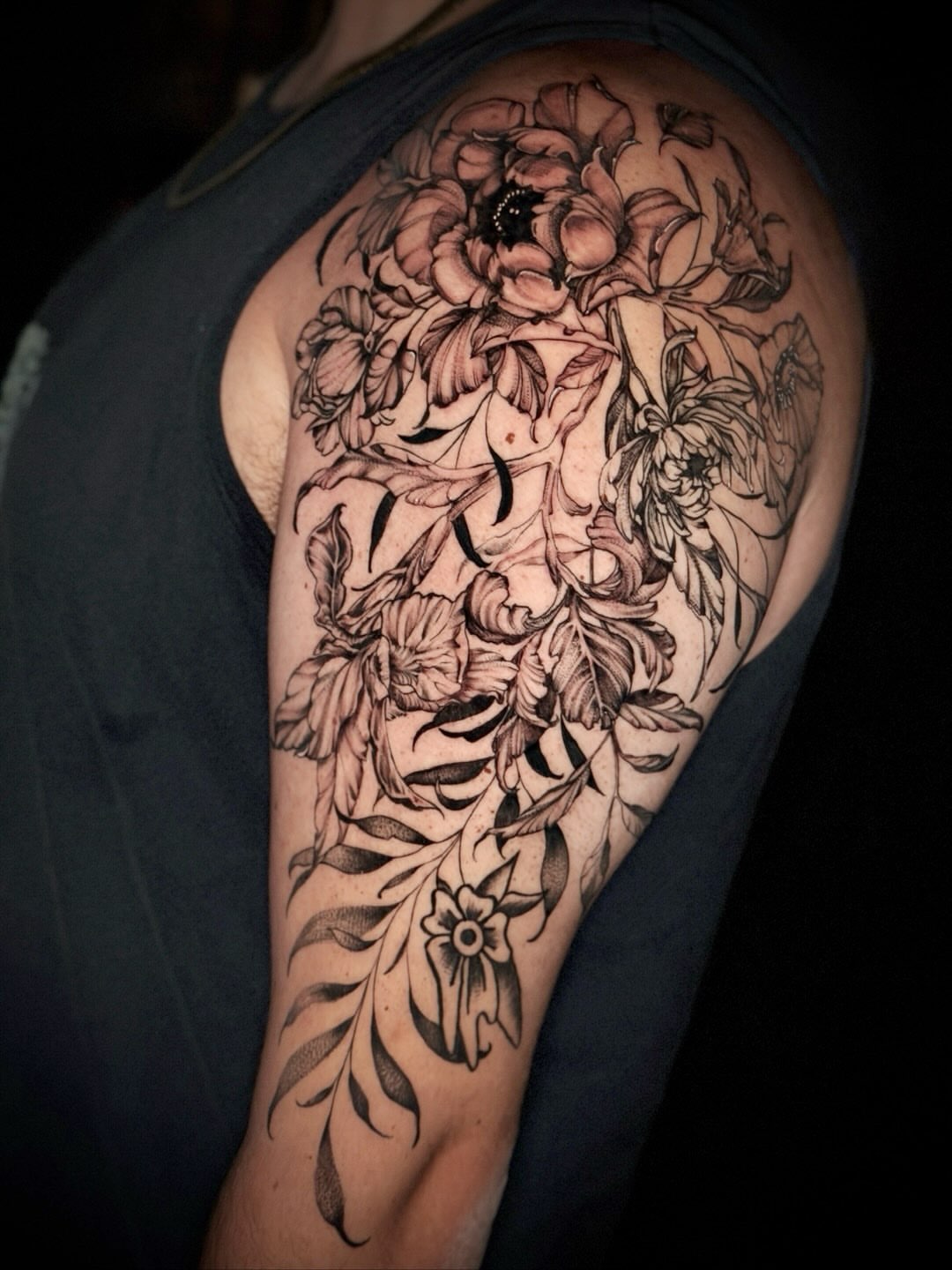 Floral arrangement black and grey tattoo on the shoulder by Giovanna Kline