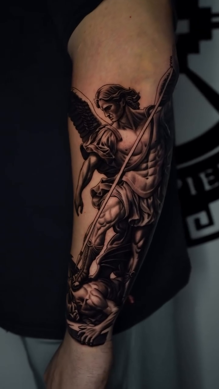 Archangel Michael battling demons realism tattoo on the forearm by Salvador Saenz Jr, Dallas, Texas