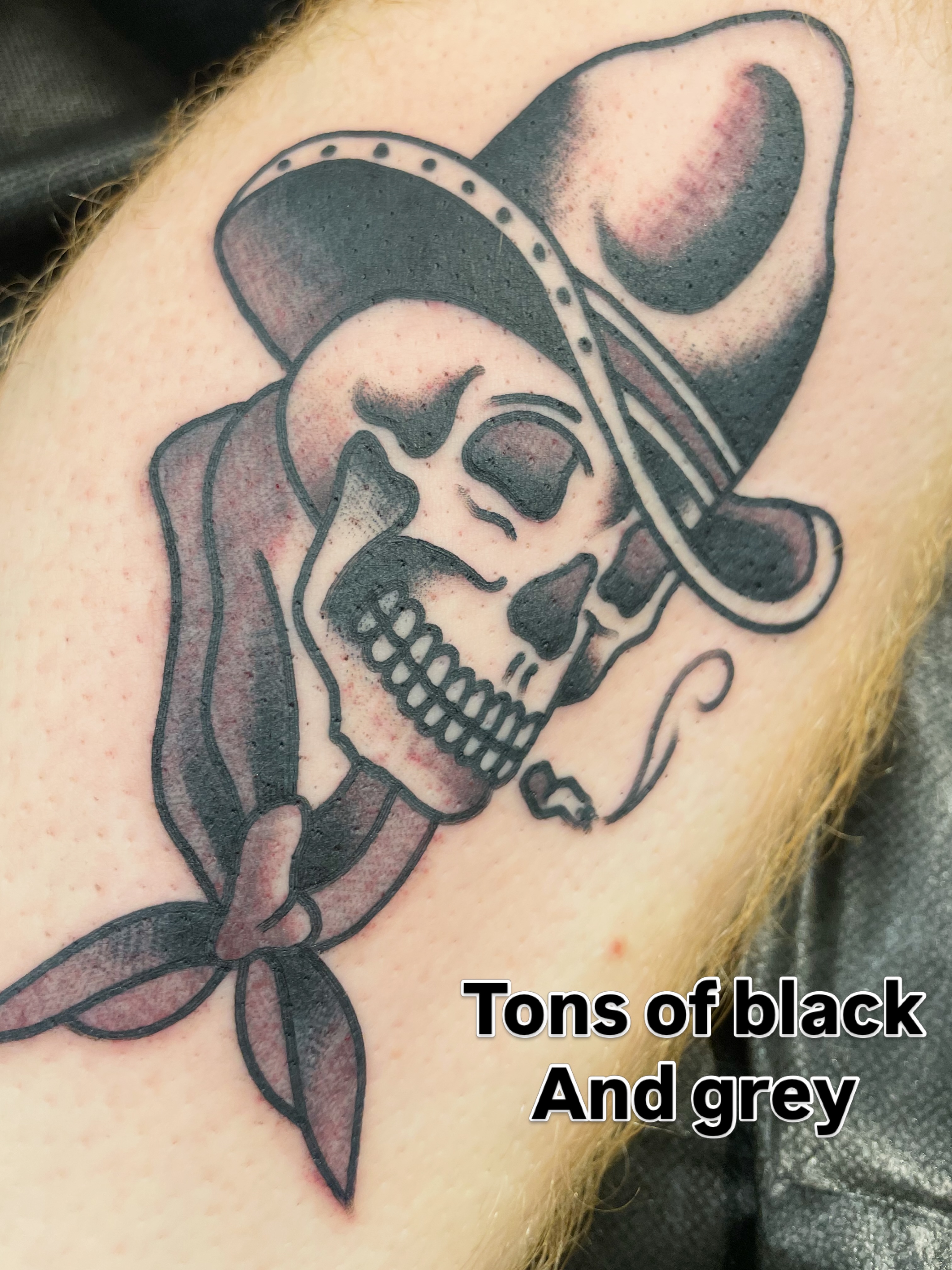 Skull wearing bandana black and grey tattoo on the forearm by matt nelson