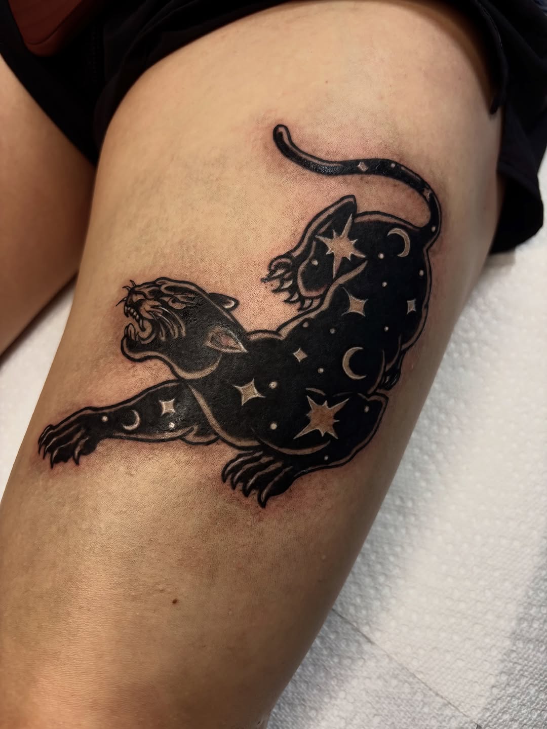 Panther with stars and moon realism tattoo on the thigh by Nashville Tattoo Artist