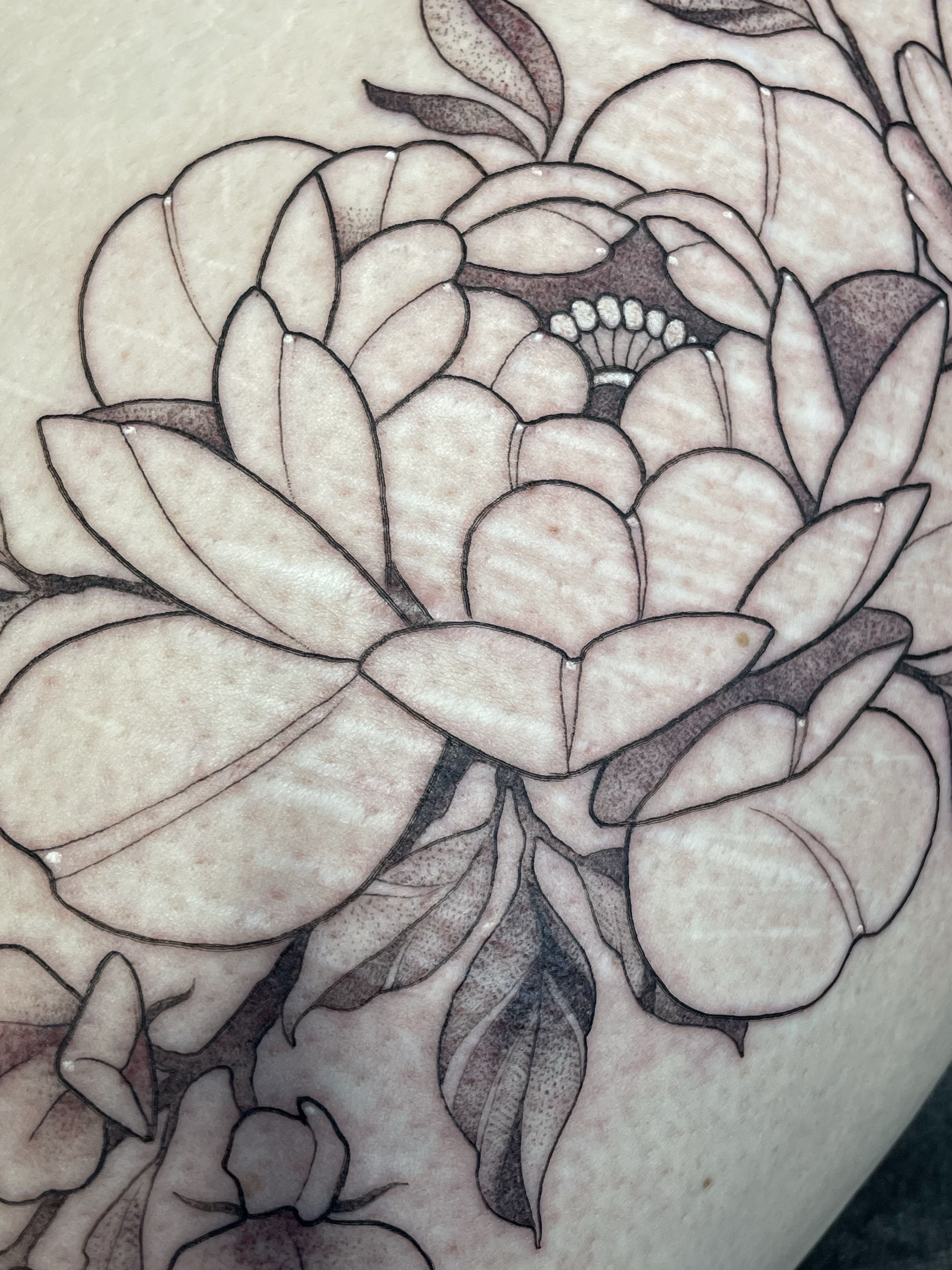 Flower black and grey tattoo on the thigh by Tanya Murski