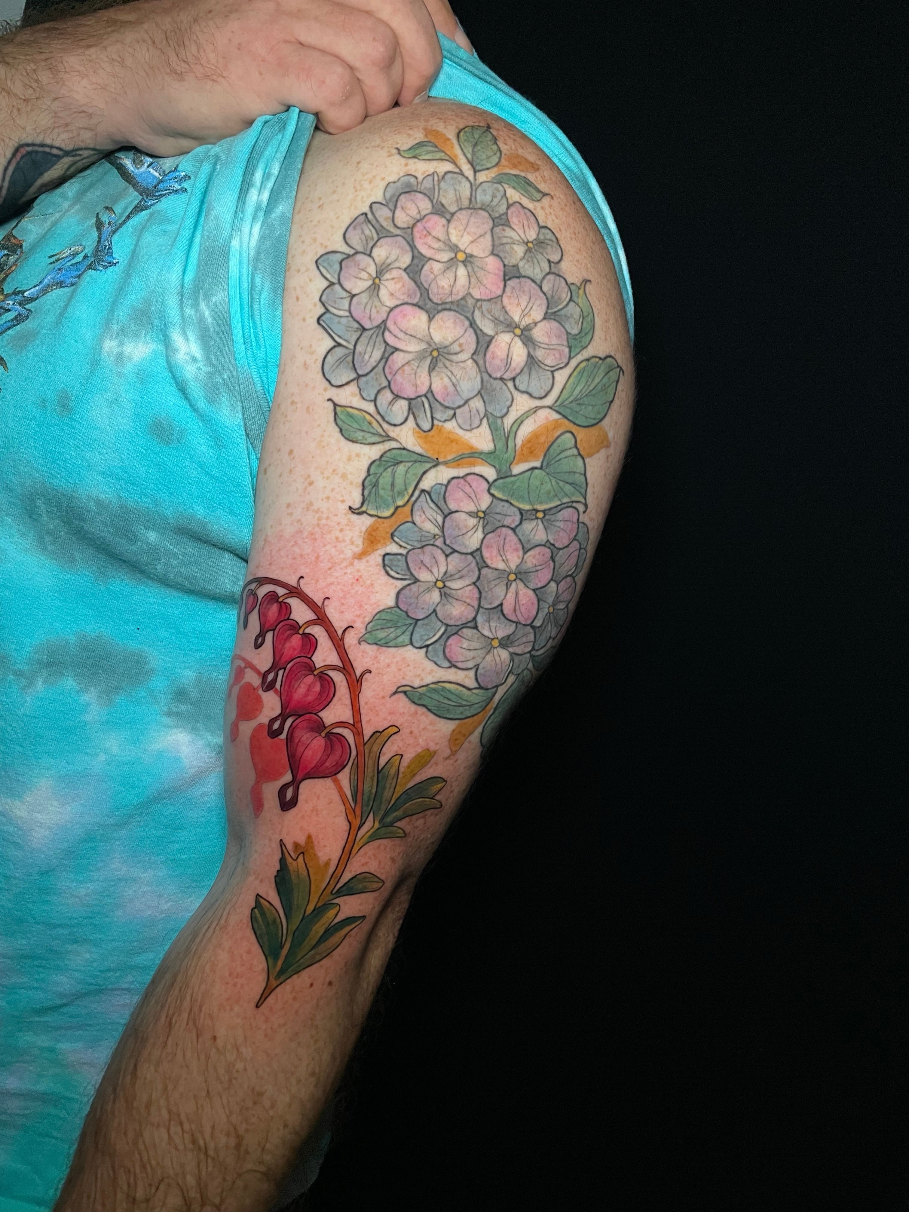 Hydrangea and bleeding hearts new school tattoo on the forearm by Tanya Murski