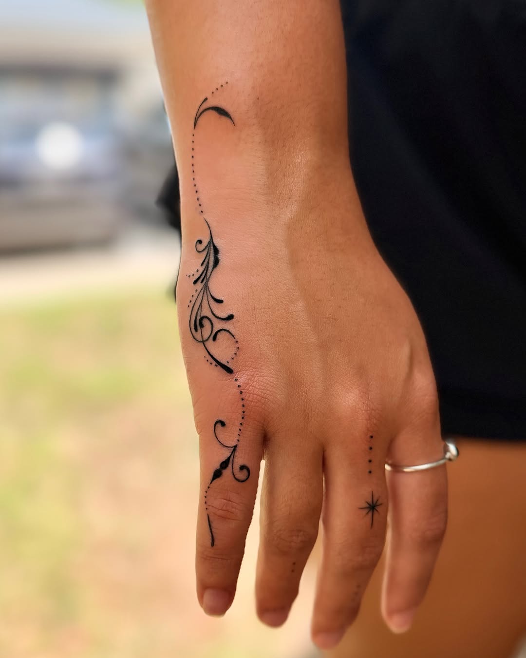 Floral vine dotwork tattoo on the hand by Emily Velletta, Huntersville, North Carolina