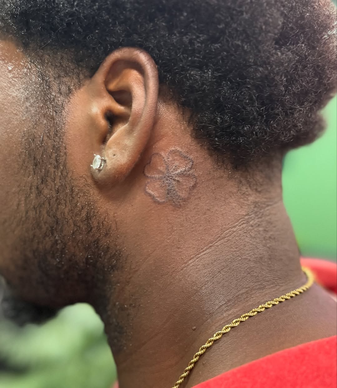 Clover black and grey tattoo on the neck by Lauren B