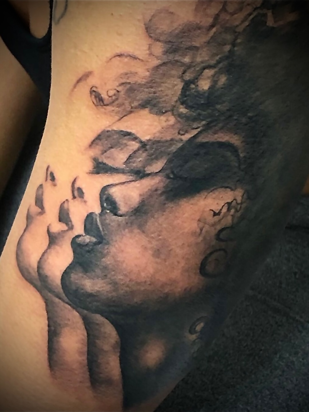 Child's face black and grey tattoo by Ray Wiggins