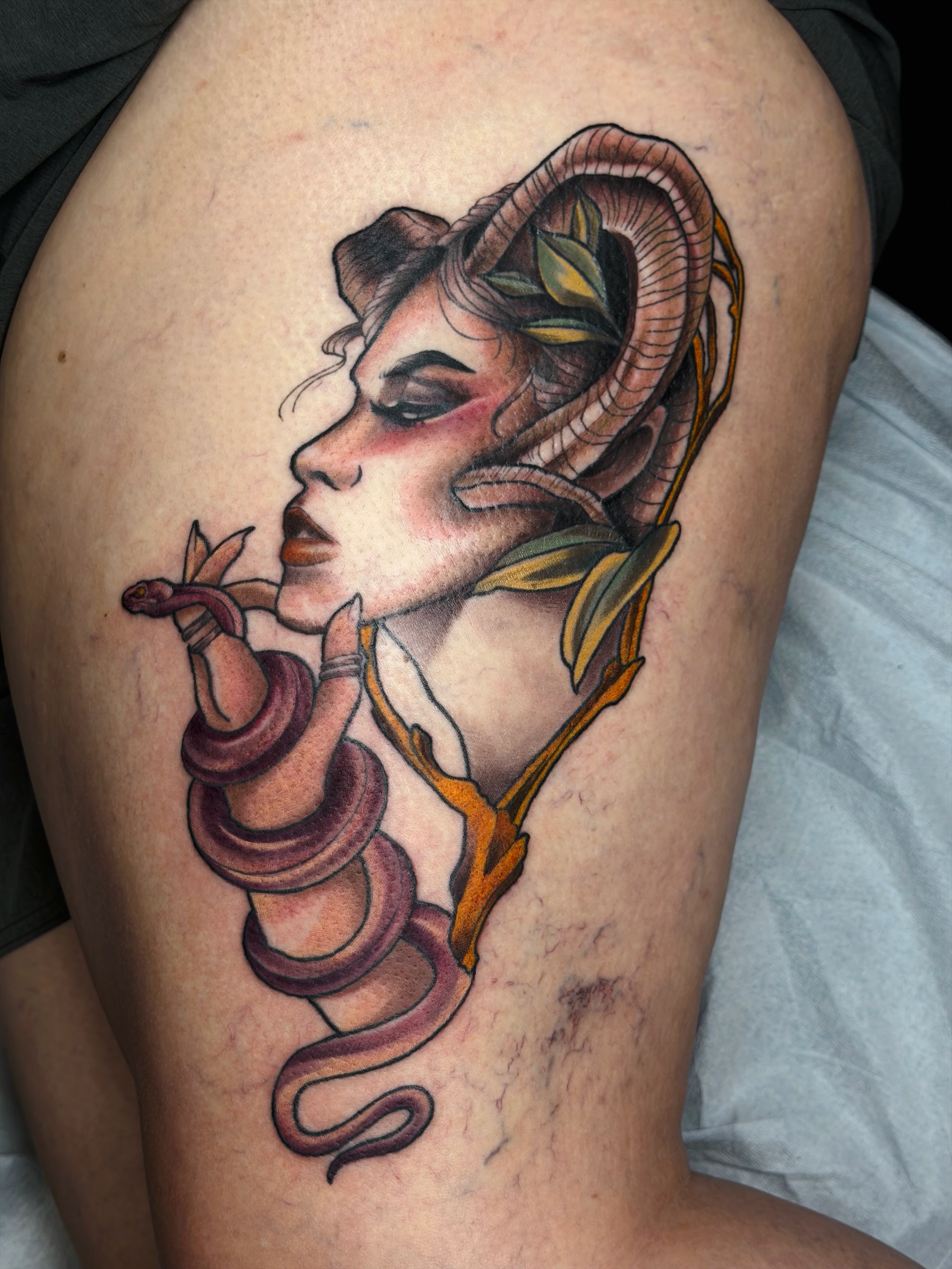 Woman with ram horns realism tattoo on the thigh by Emily