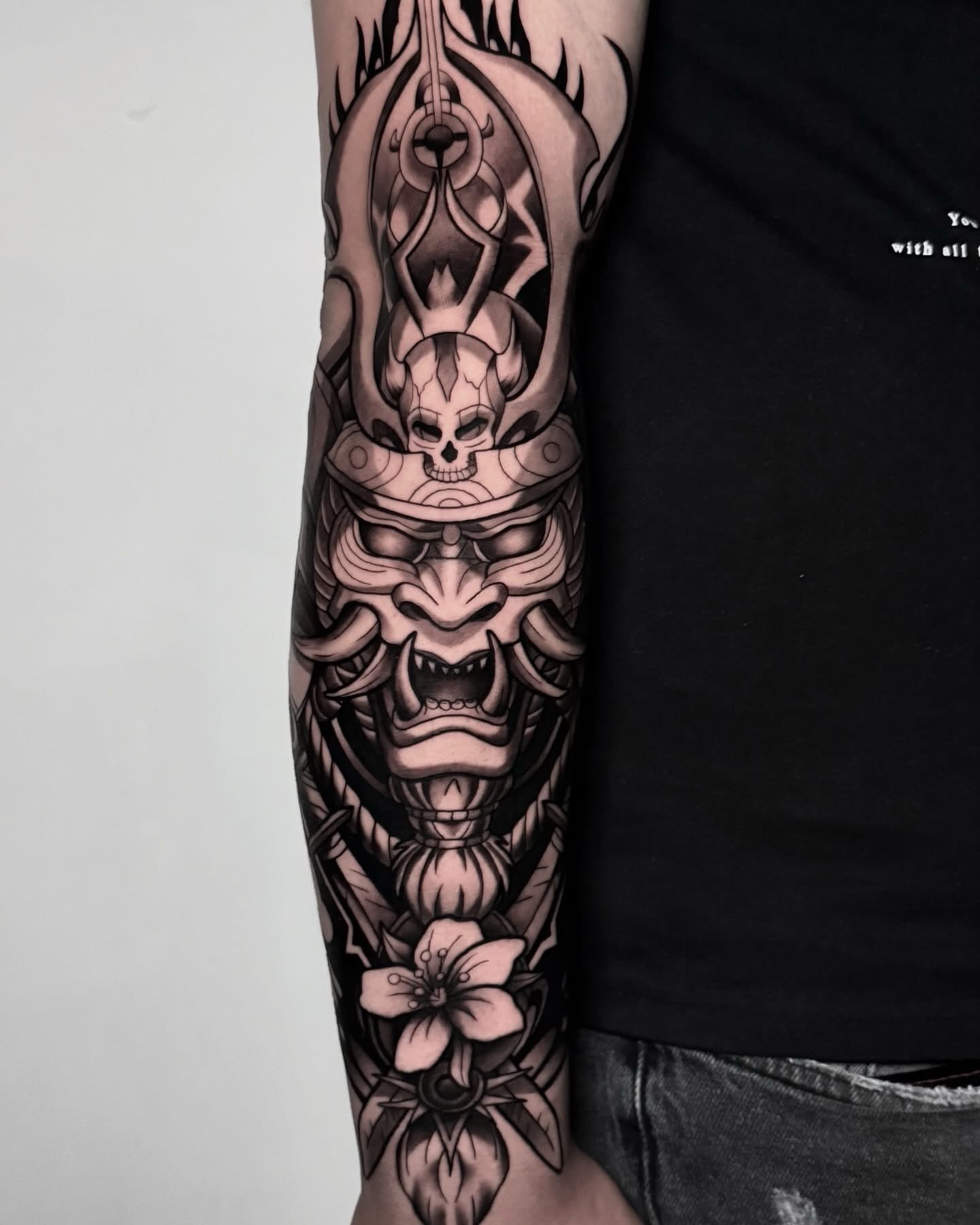 Demon mask with cherry blossom japanese irezumi tattoo on the forearm by Elijah Tattoos, San Diego, California