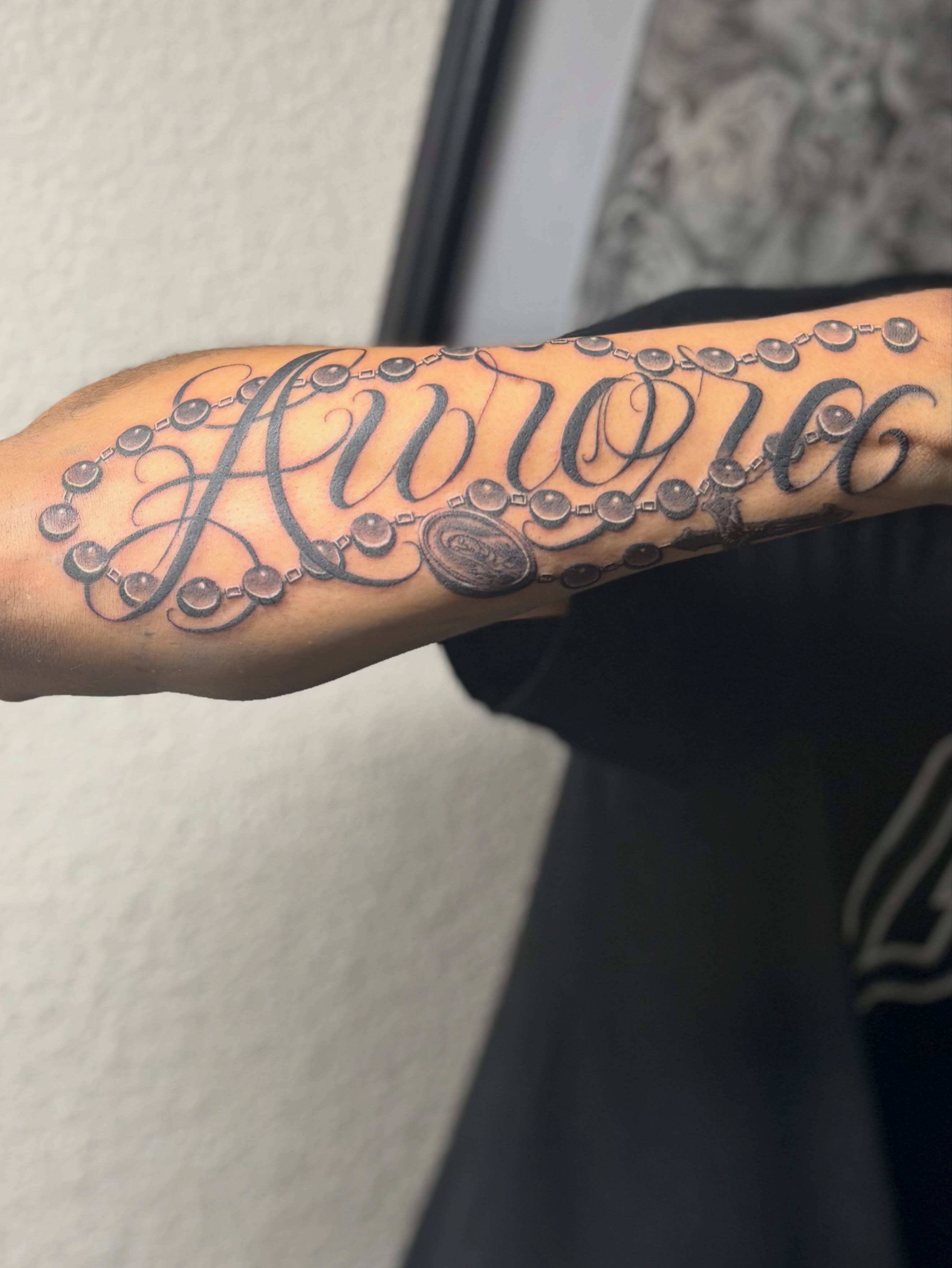 Religious phrase lettering script tattoo on the forearm by @tattoosbyadrian