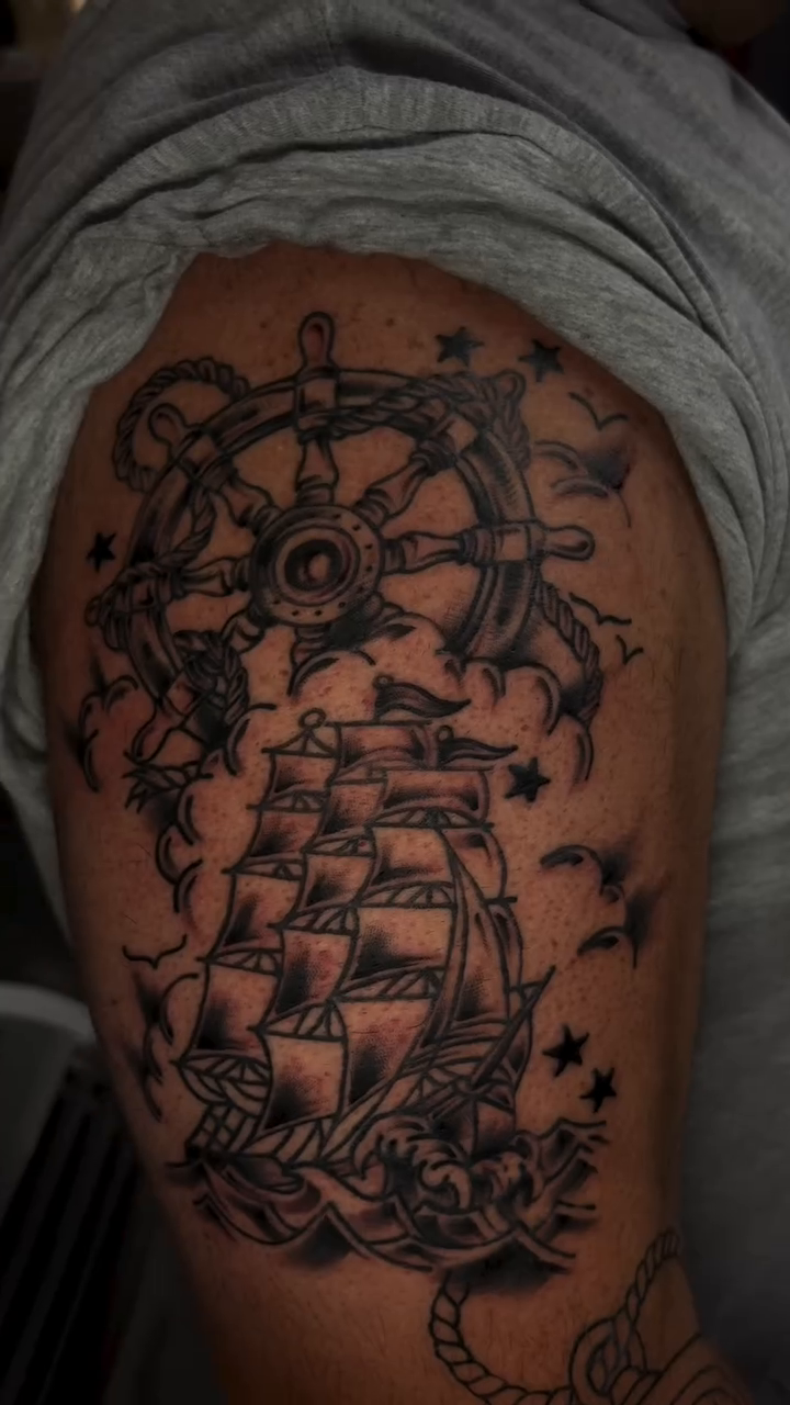 Nautical sleeve with ship and compass realism tattoo on the shoulder by Jenna Clayton