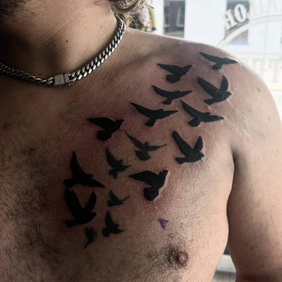 Birds black and grey tattoo on the chest by Landon Bagley