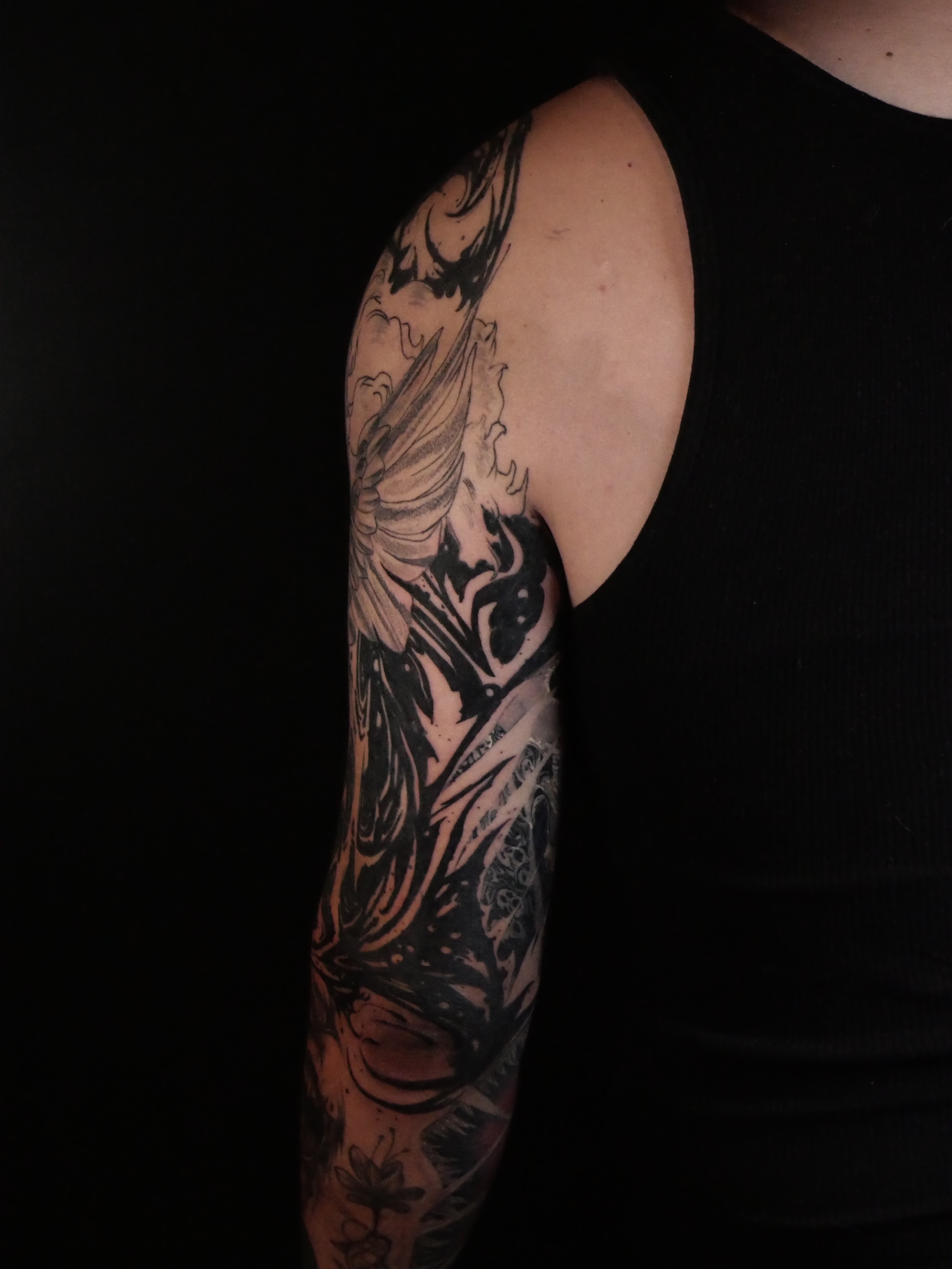 Abstract figure dotwork tattoo on the upper arm by Sloppy