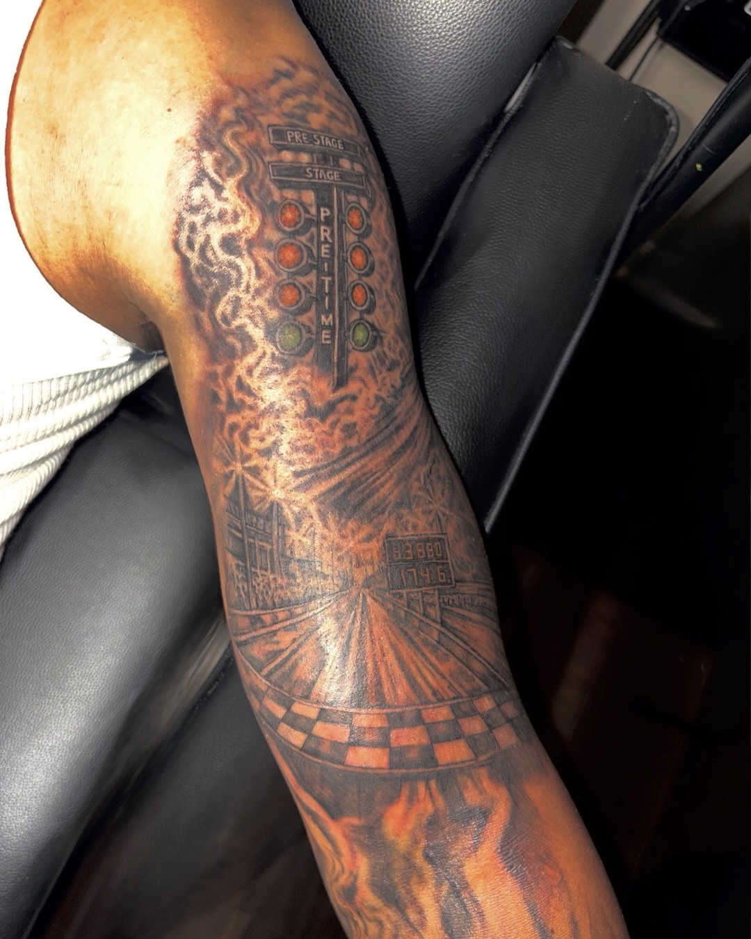 Race track realism tattoo on the forearm by K.L Tattoo Uptown