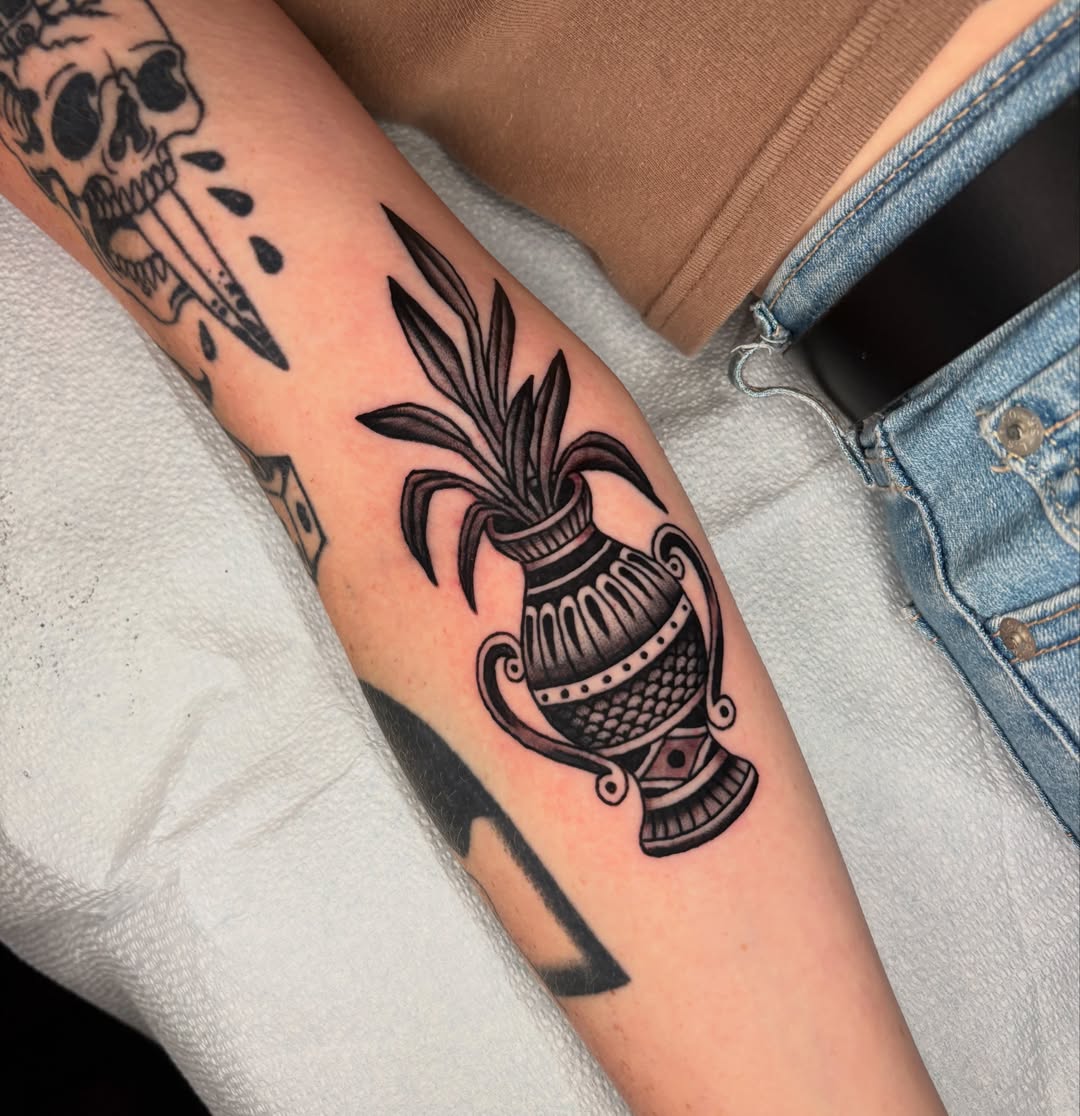 Urn with plant black and grey tattoo on the forearm by Max Klapp, Austin, Texas
