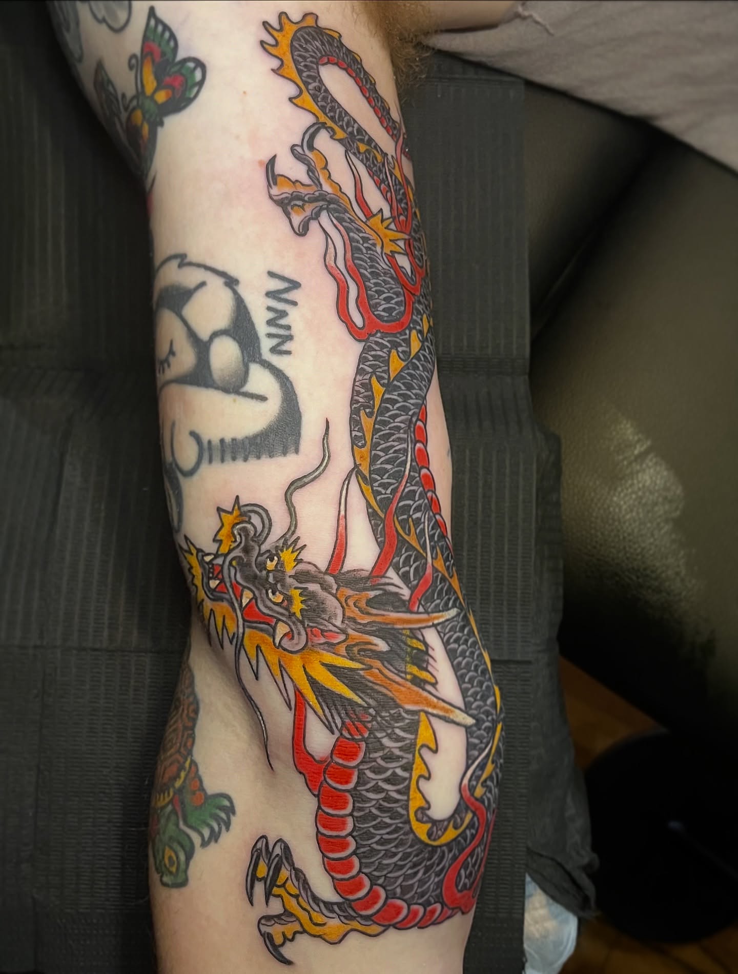 Dragon American traditional tattoo on the forearm by Andrew Snowden