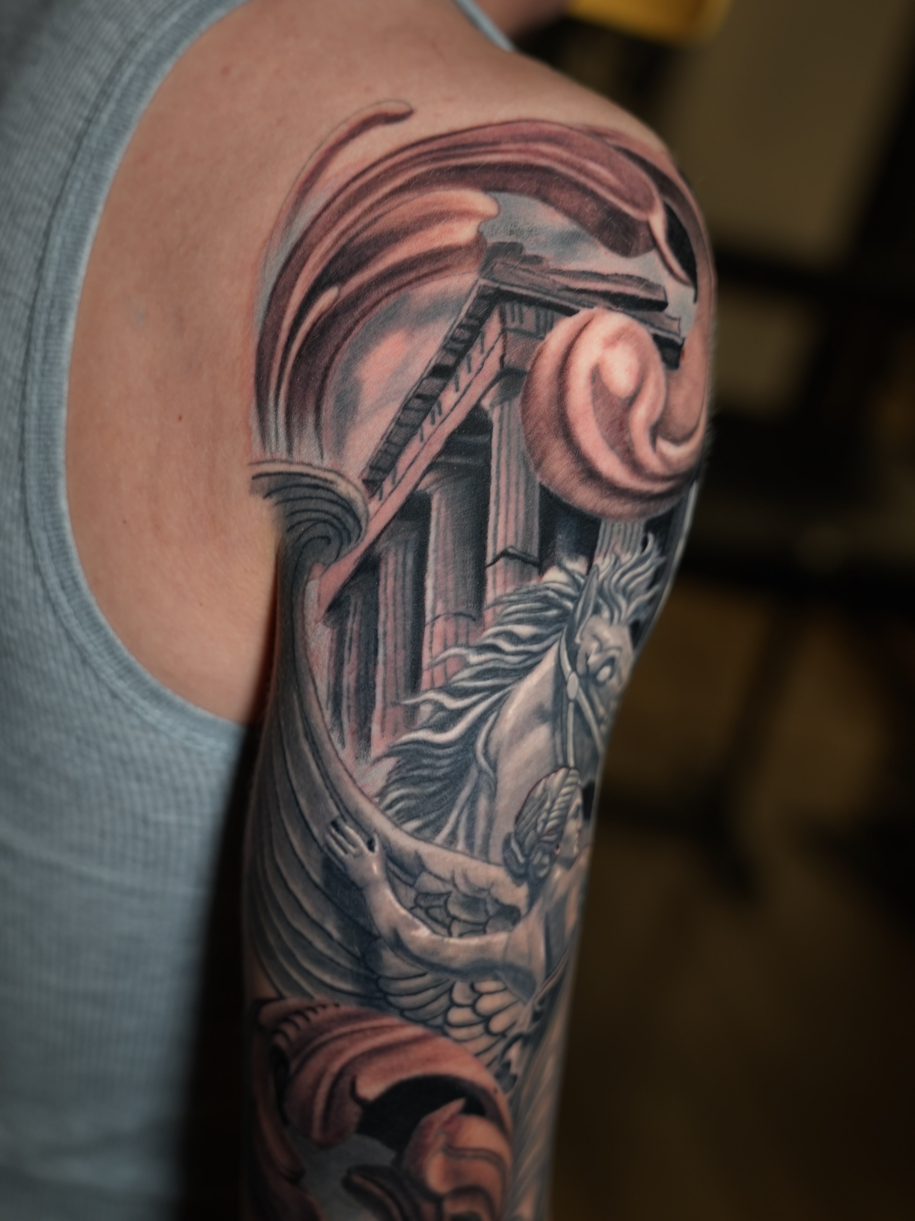 Mythical creature realism tattoo on the upper arm by Antonio Arias