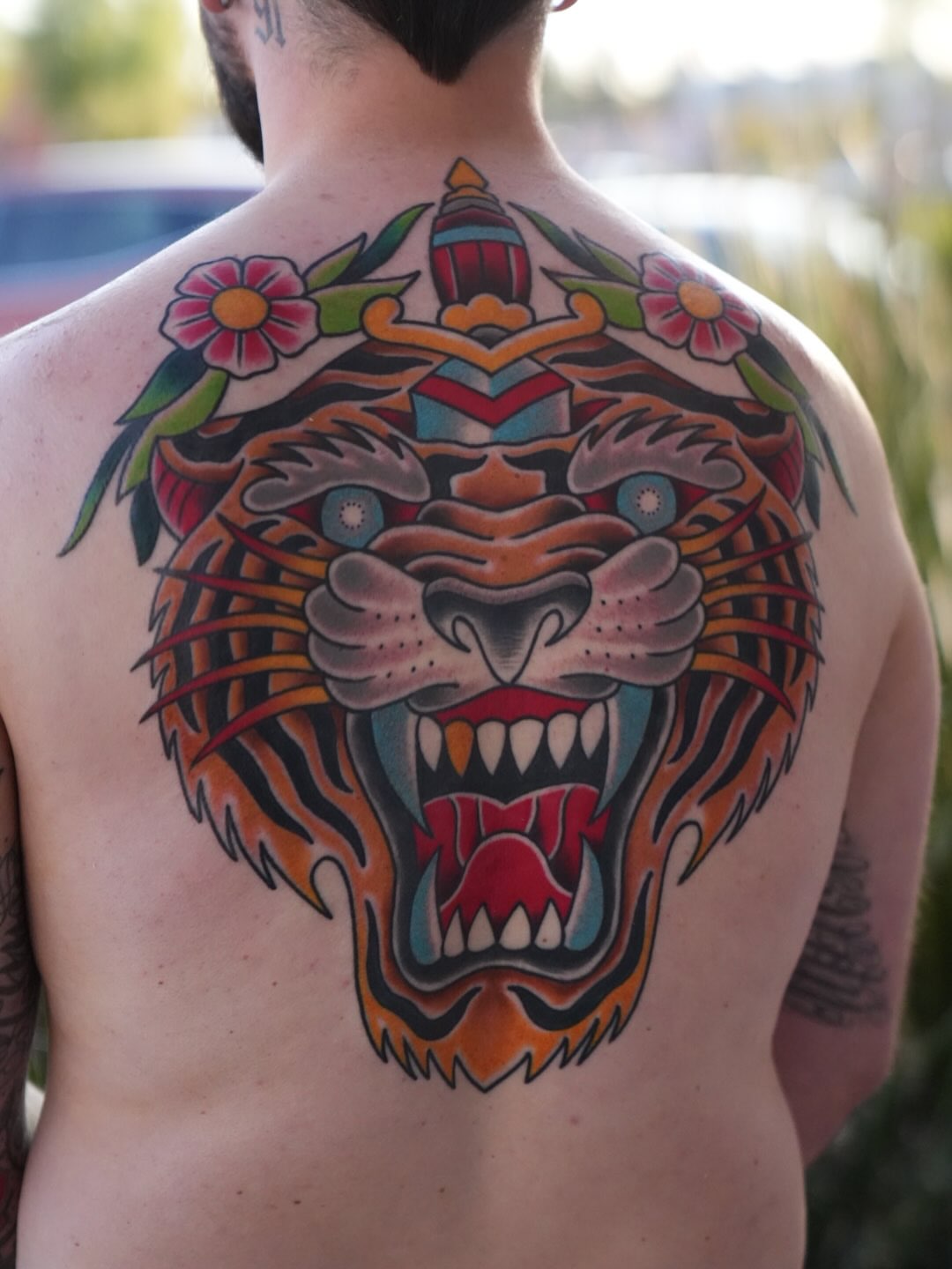 Roaring tiger American traditional tattoo on the back by Donovan hernandez