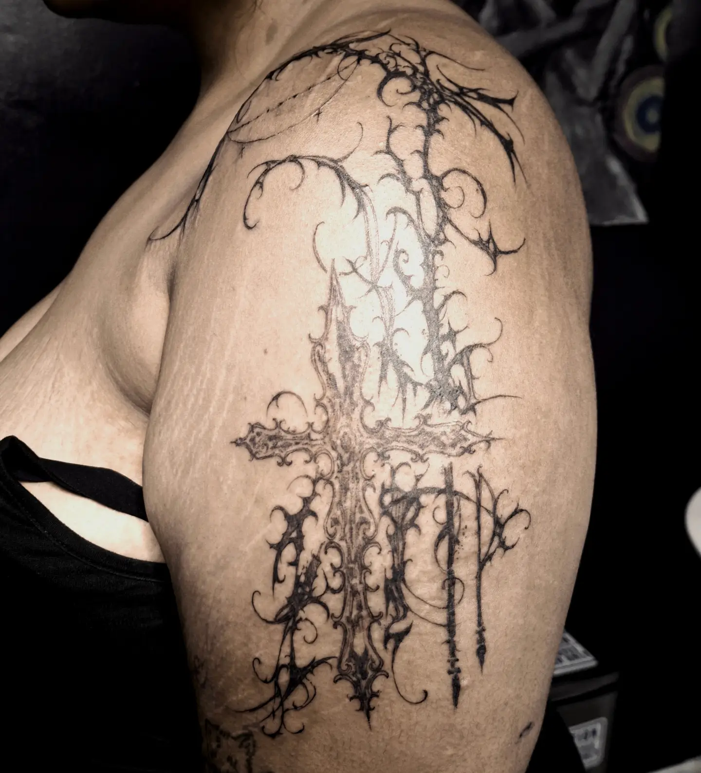 Cross black and grey tattoo on the shoulder by hallowed girl tattoo