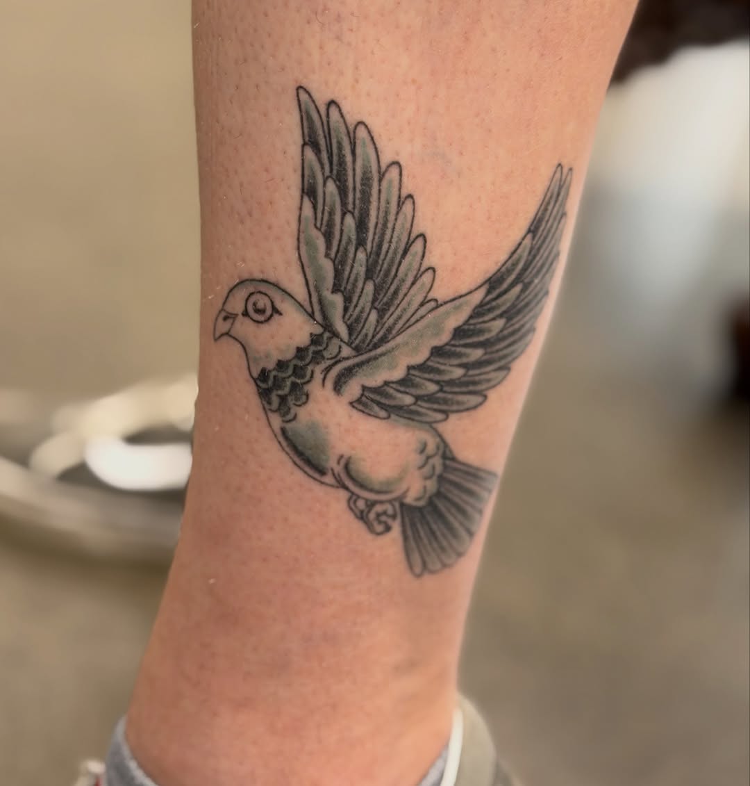 Dove fine line tattoo on the forearm by Michelle