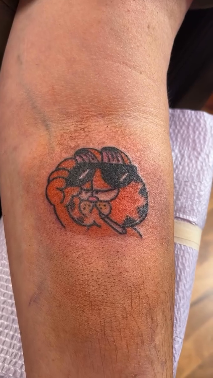 Garfield with sunglasses minimalist tattoo on the forearm by Cortney "Fett" Fettinger, Fort Wayne, Indiana