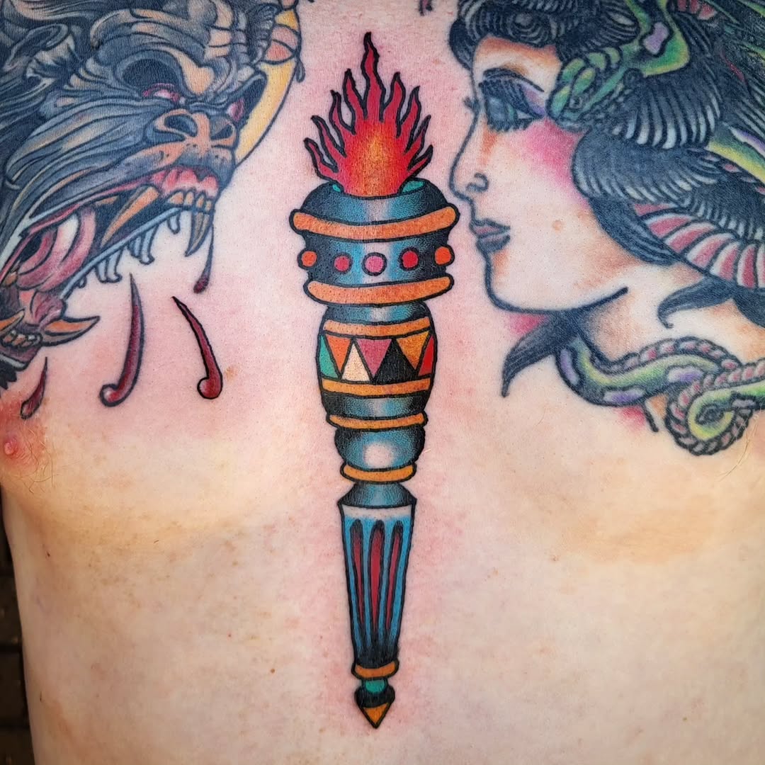 Torch American traditional tattoo on the chest by Sloan Smith