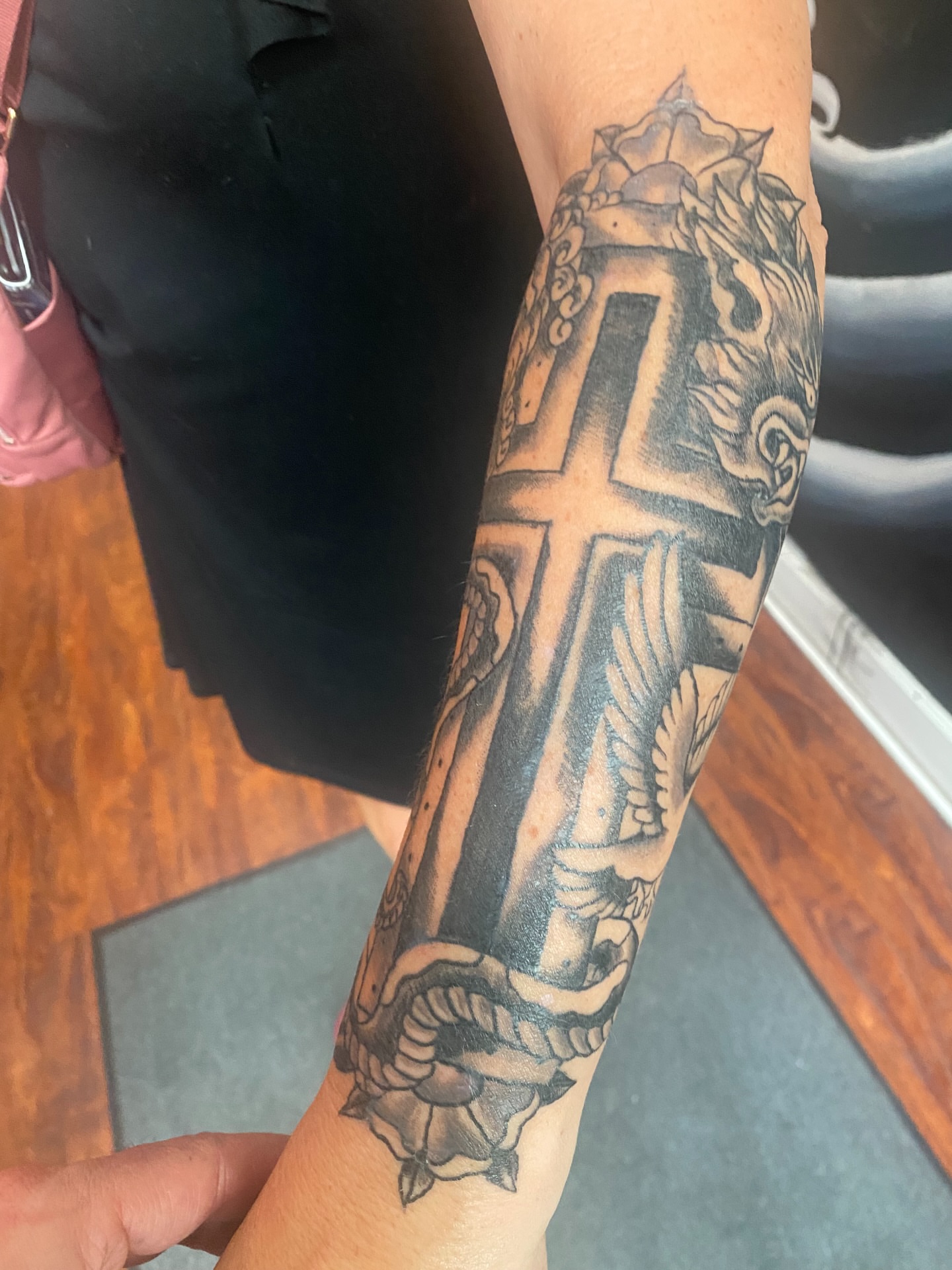 Cross black and grey tattoo on the forearm by Christopher Sanders