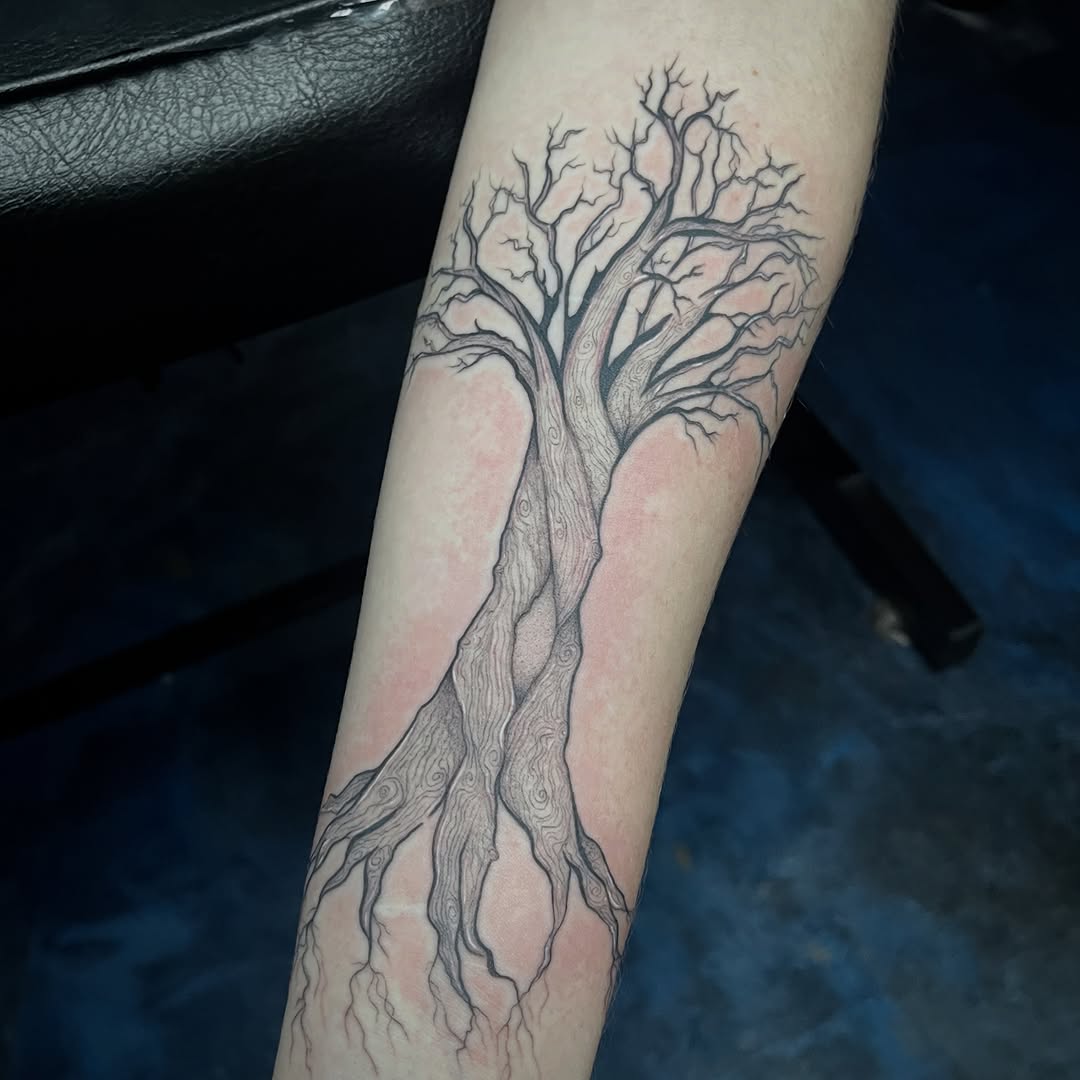 Bare tree with roots dark art tattoo on the forearm by Sid