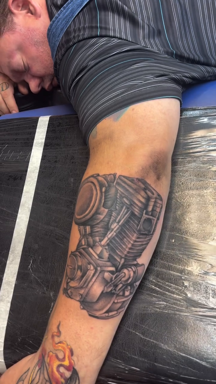 Motorcycle engine realism tattoo on the forearm by Sam Hearnen, Lawrence, Kansas