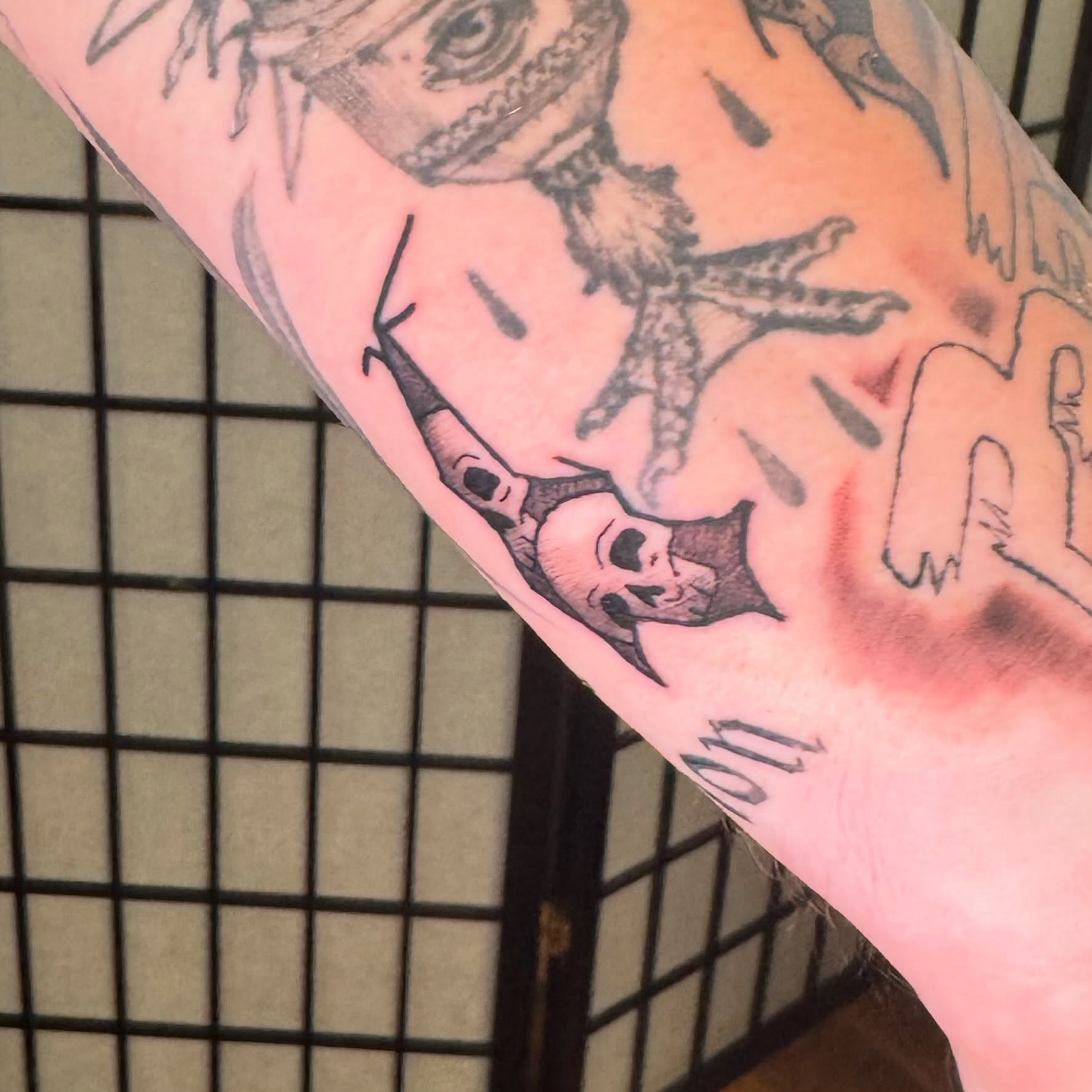 Octopus and skull black and grey tattoo on the forearm by Zac Smith-Chevalier