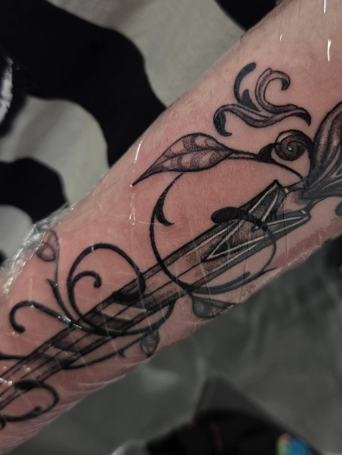 Violin black and grey tattoo on the forearm by Devin 🖤