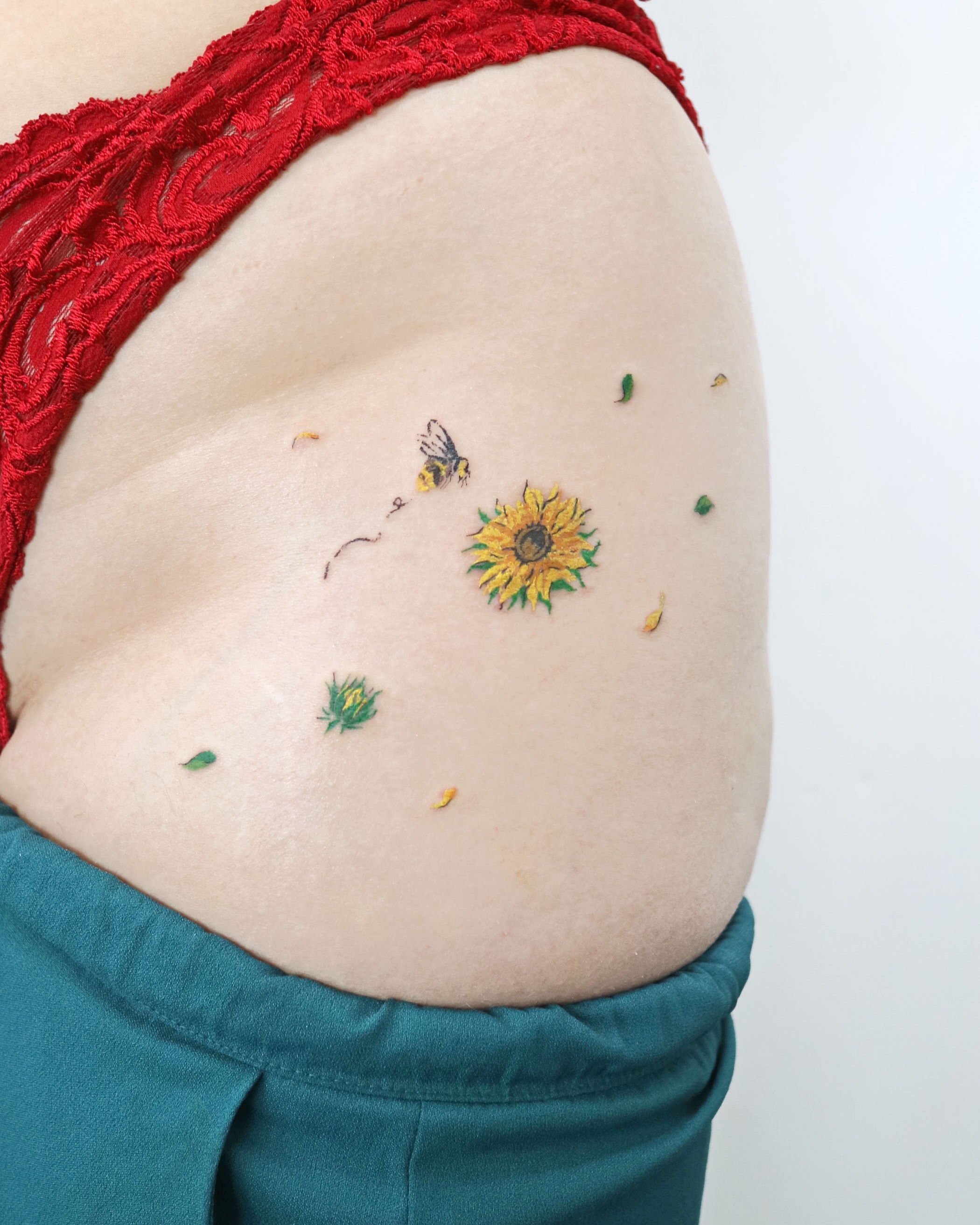 Sunflower and bee realism tattoo on the shoulder by Aroha