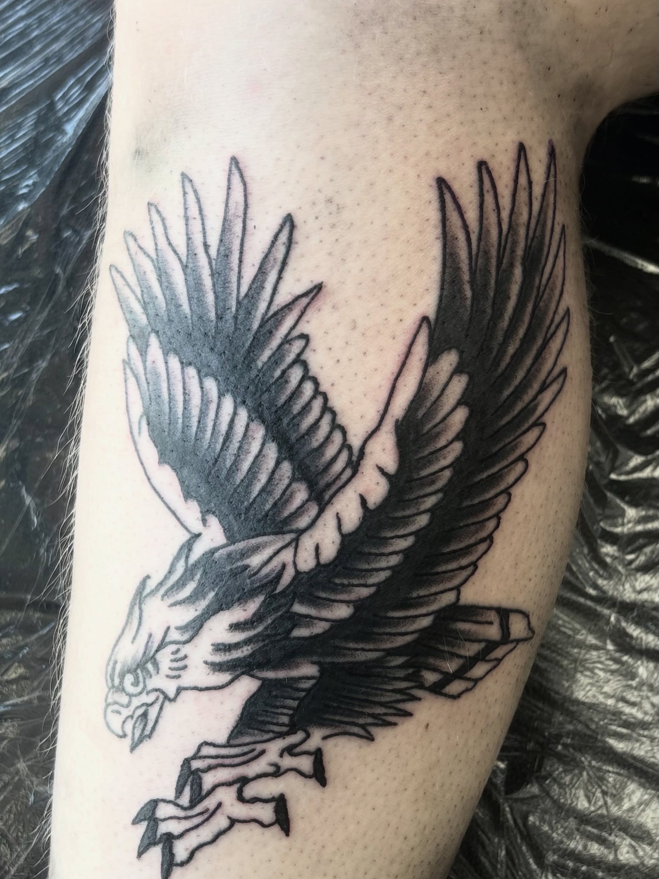 Eagle black and grey tattoo on the forearm by Landon Bagley