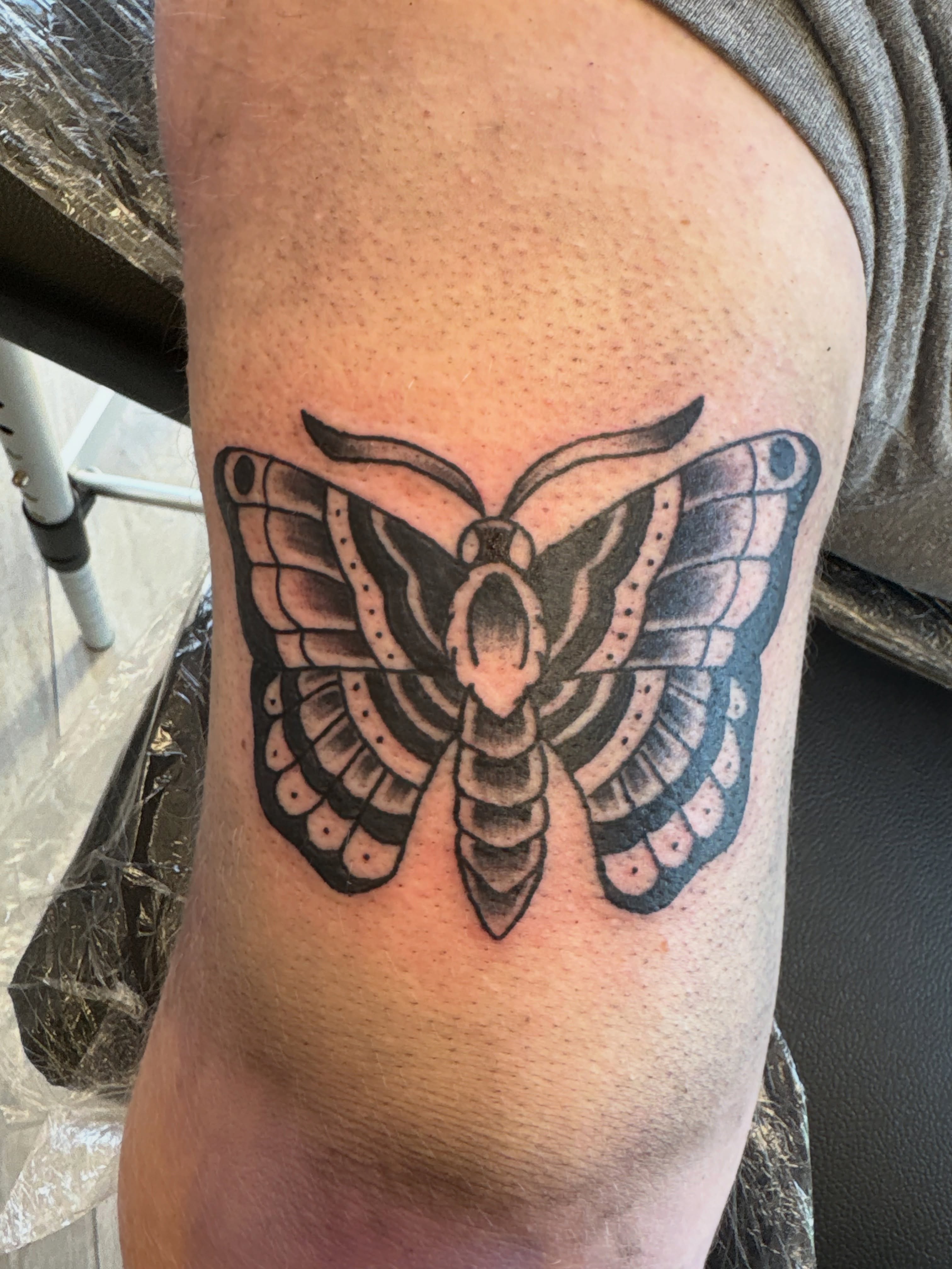 Moth black and grey tattoo on the thigh by Landon Bagley