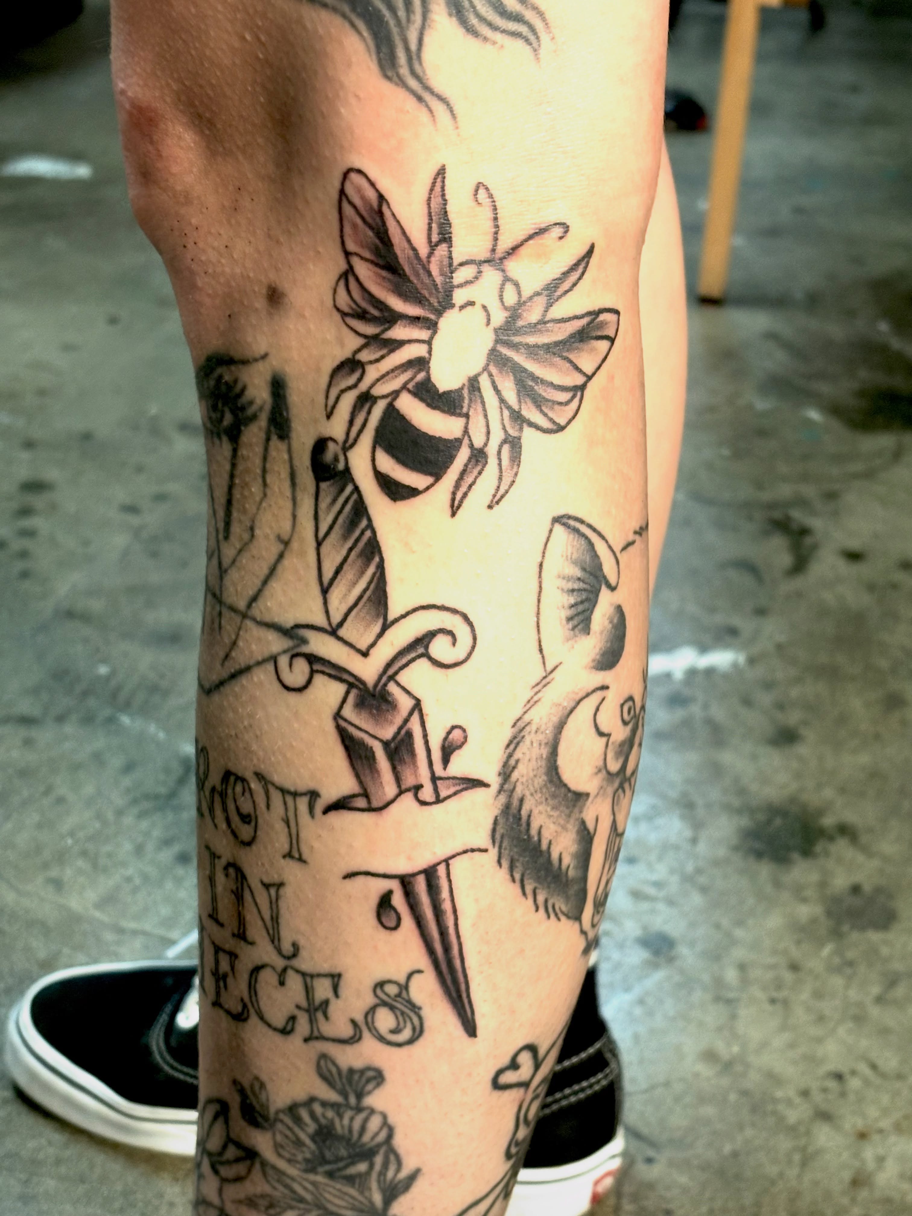 Bee and dagger black and grey tattoo on the forearm by Landon Bagley