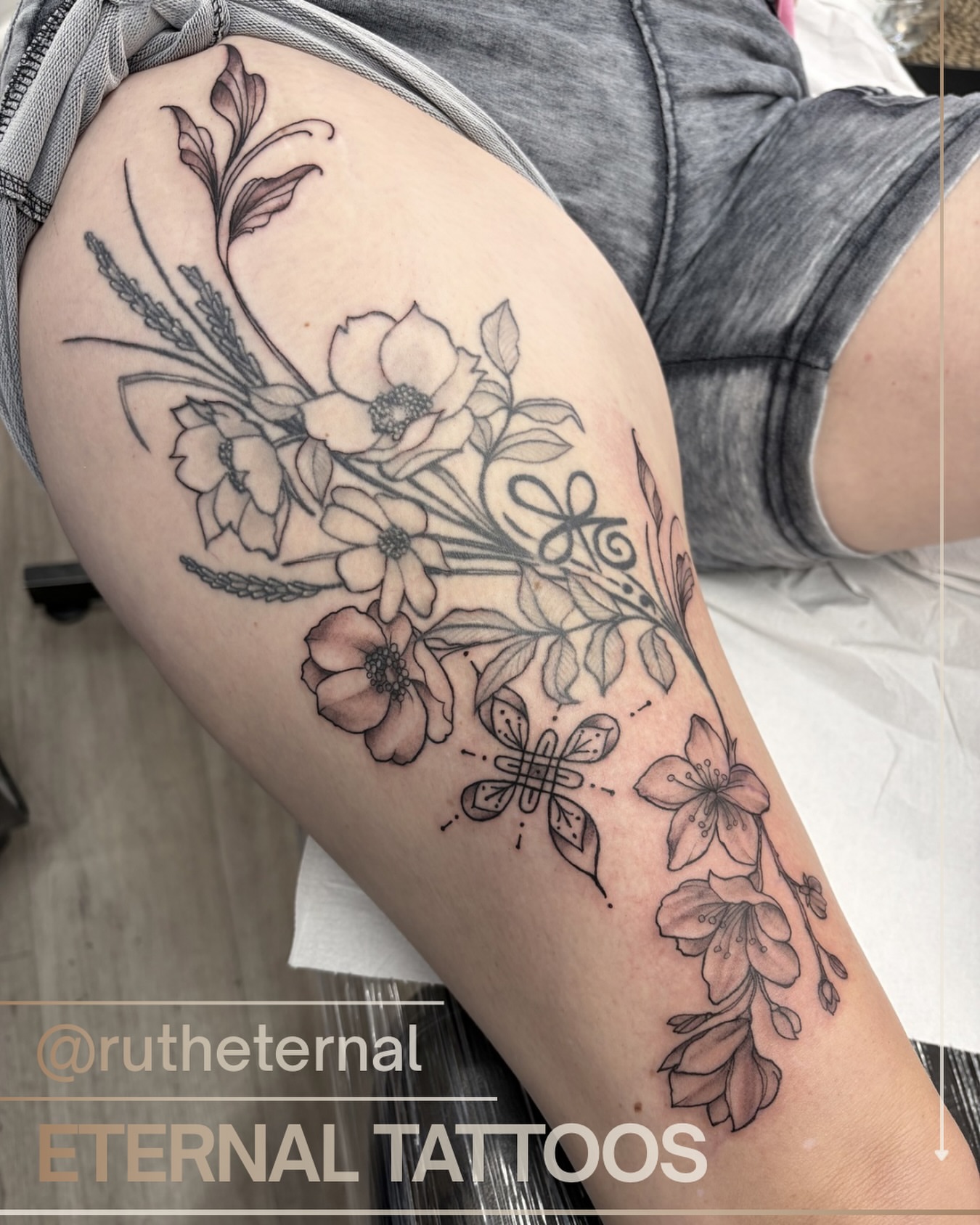 Floral bouquet realism tattoo on the thigh by Ruth Ormsby-Ashworth