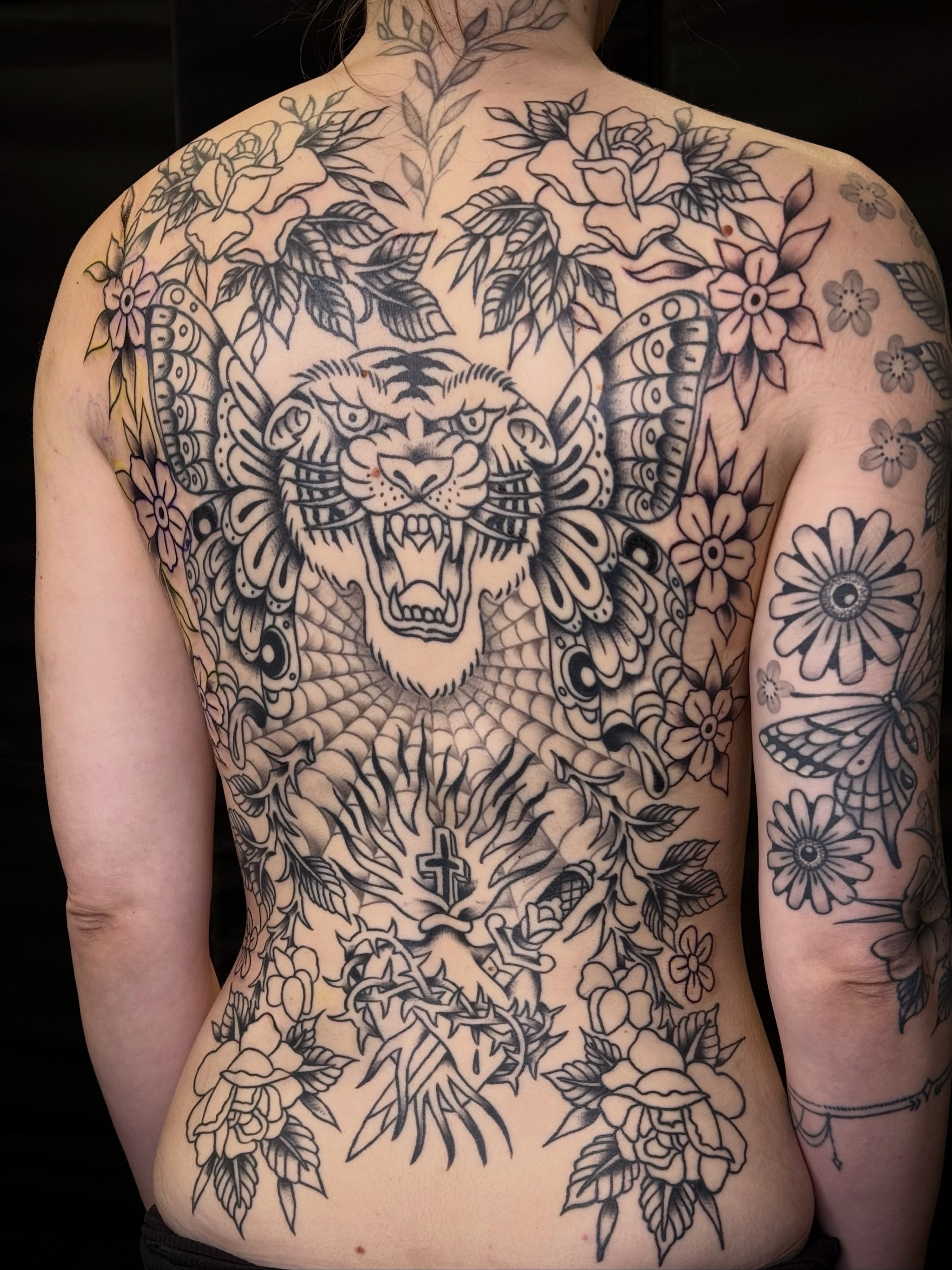 Panther and floral ornamental tattoo on the back by Dave Kruseman
