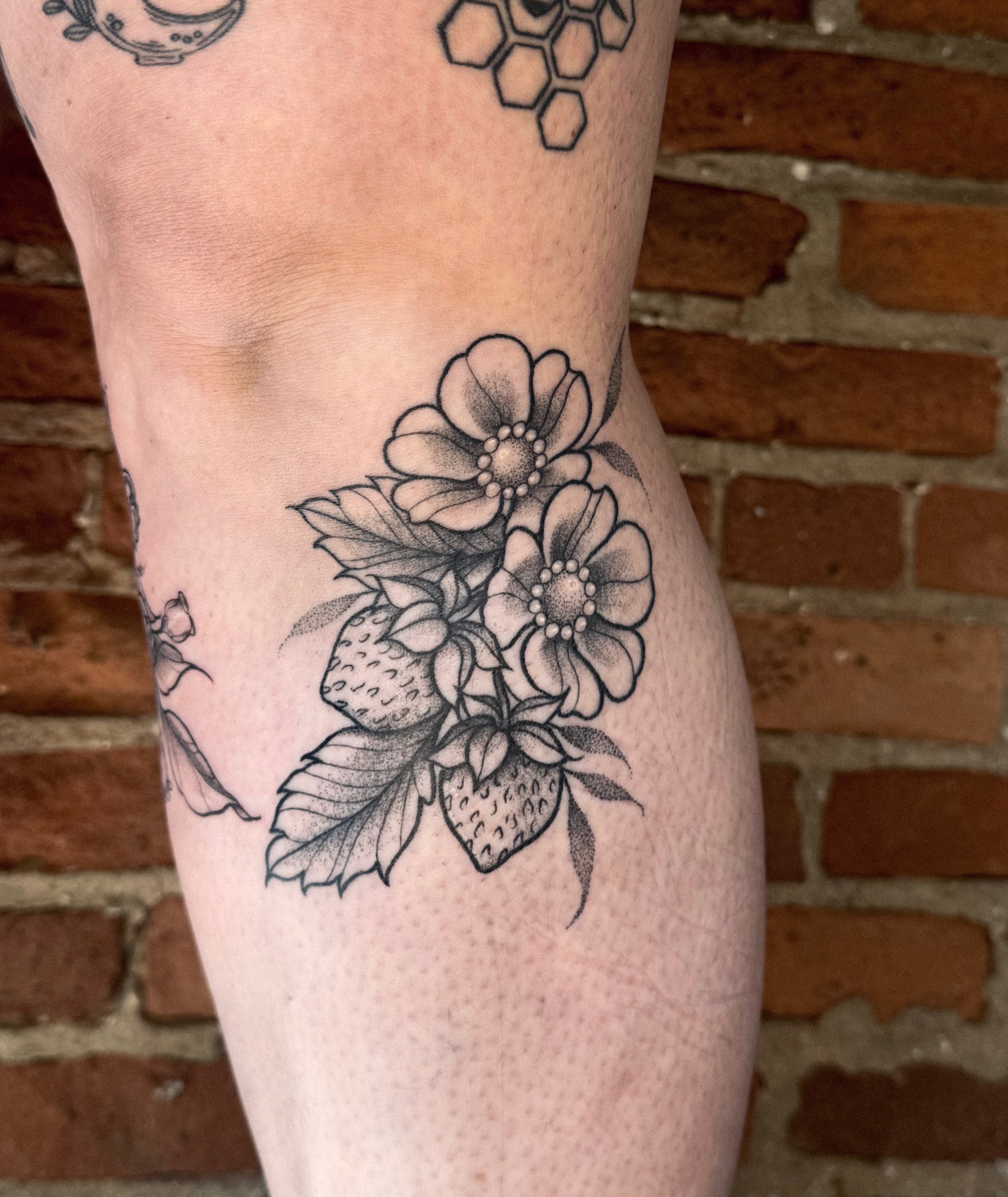 Strawberries and flowers dotwork tattoo on the thigh by Jessica Bloom