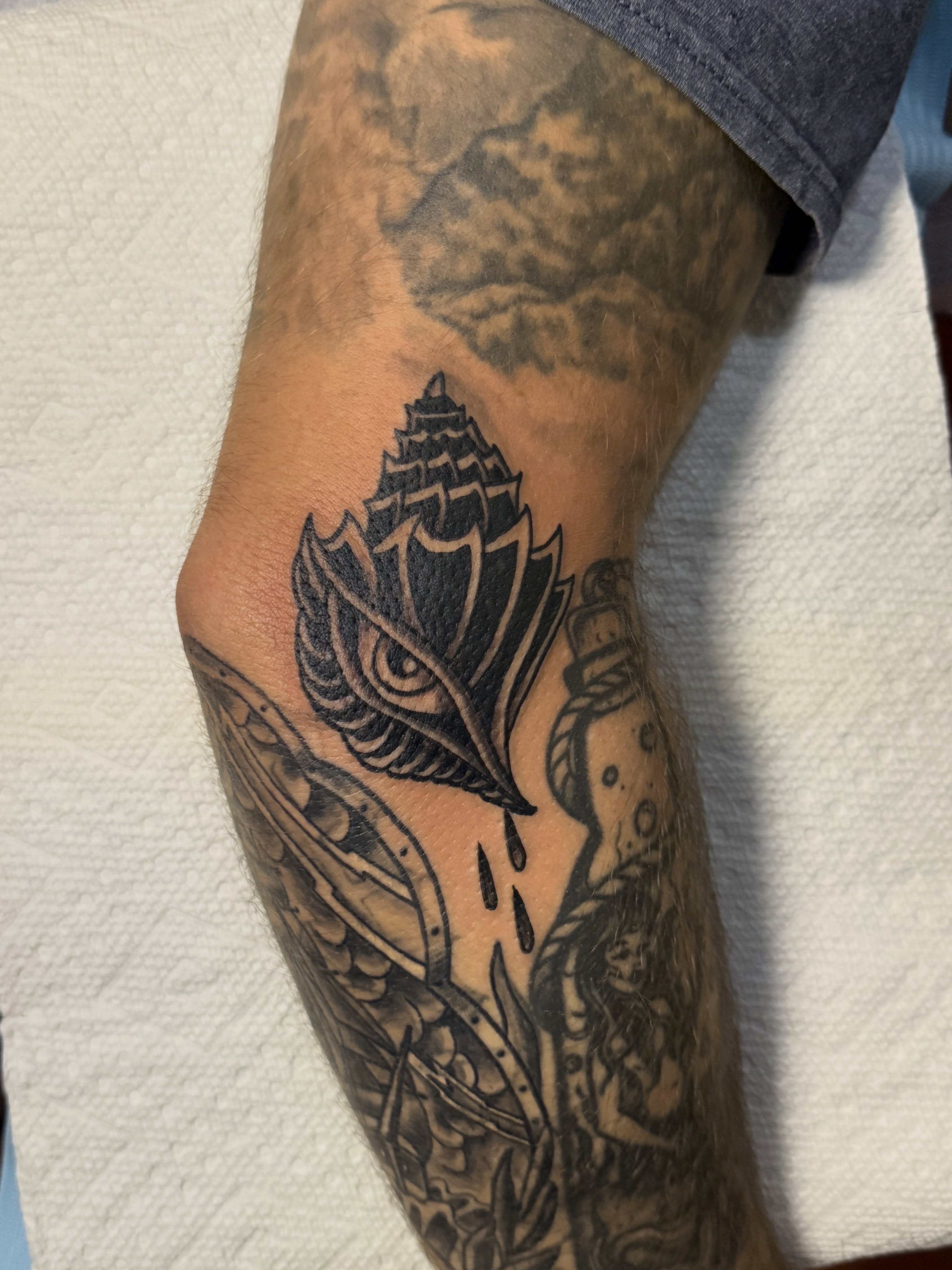 Seashell and mermaid geometric tattoo on the forearm by Andre Guerra