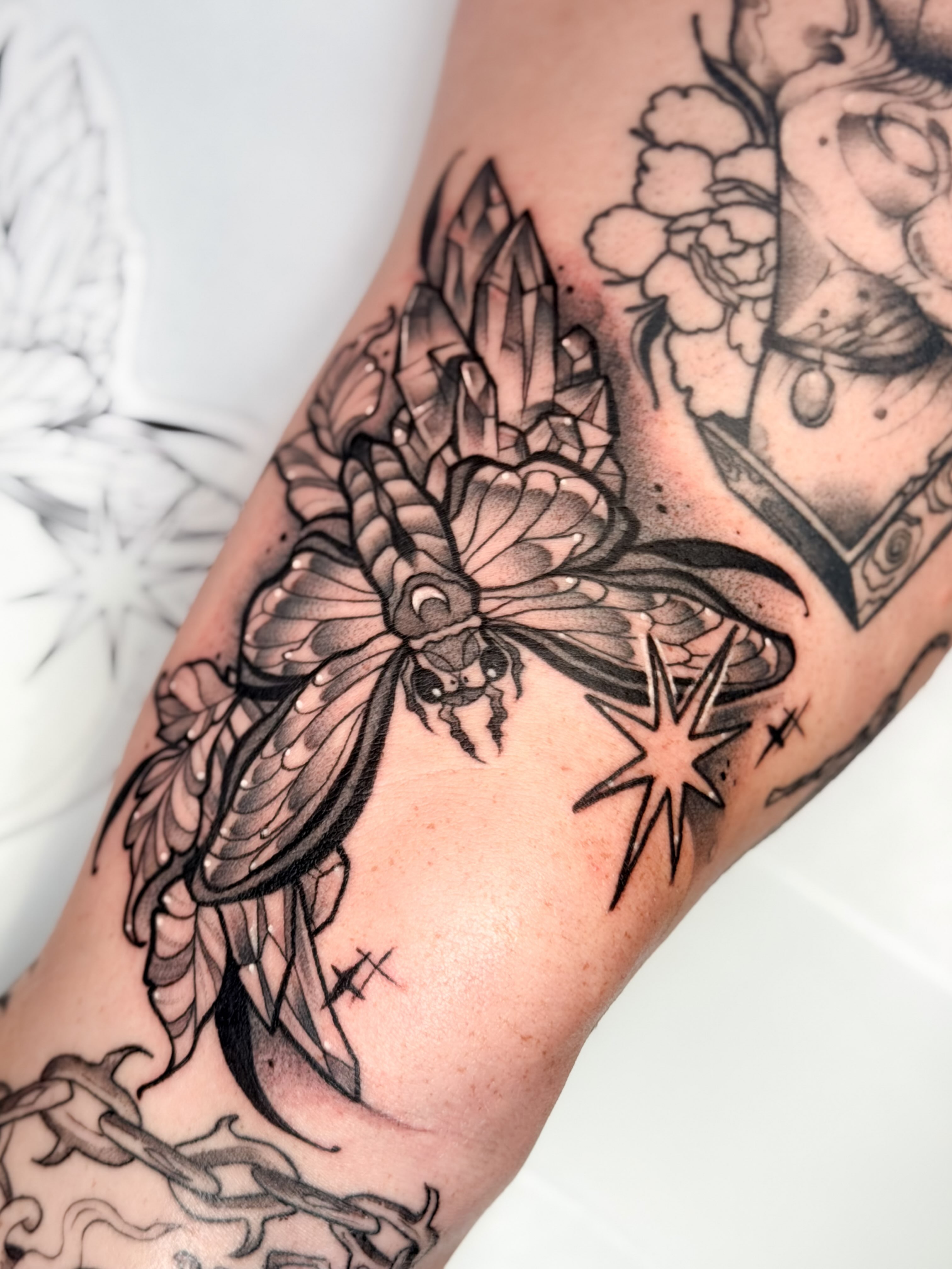 Insect and crystal geometric tattoo on the forearm by Constance Roberts