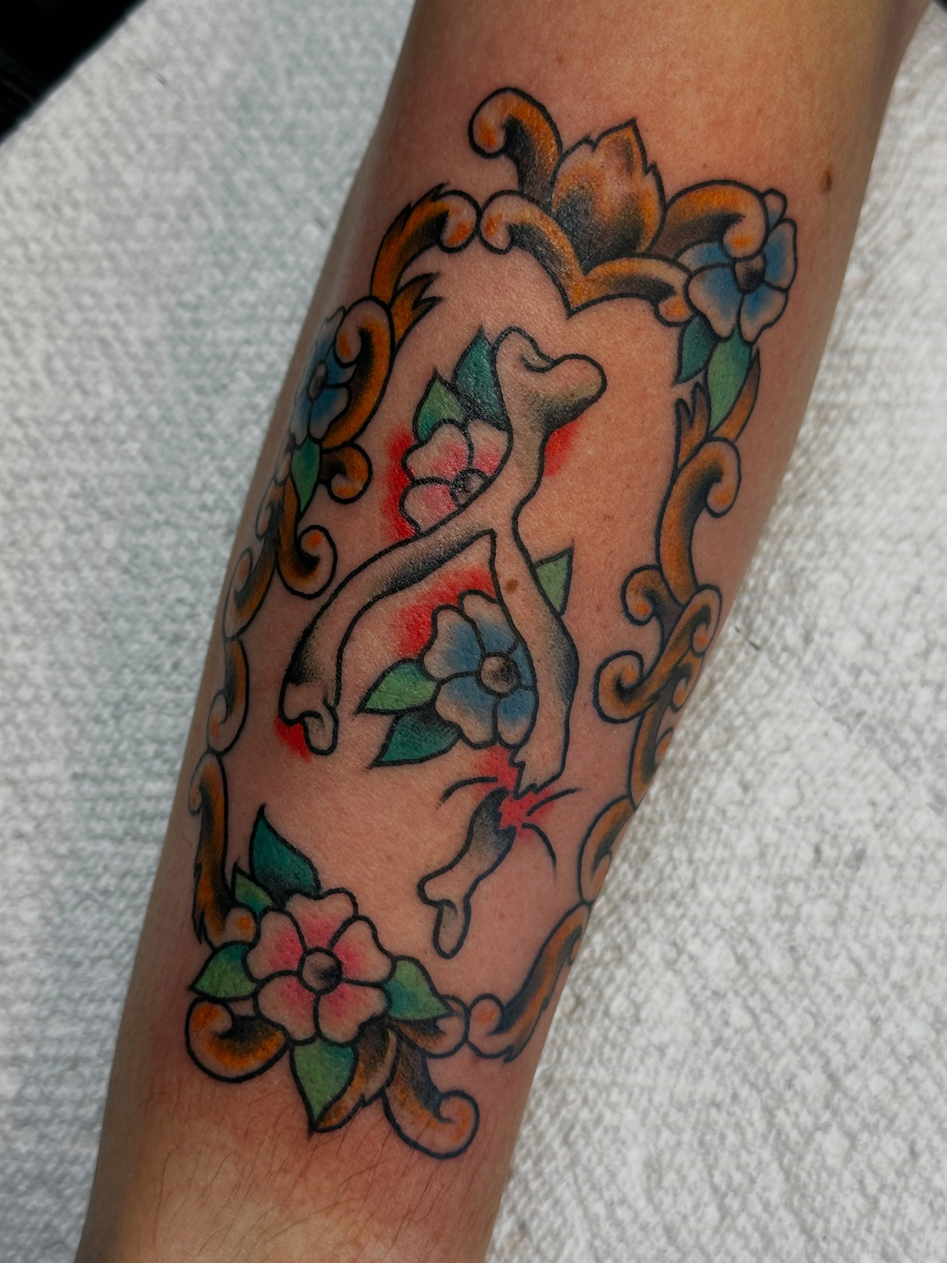 Floral crest American traditional tattoo on the forearm by Elisha B🦷
