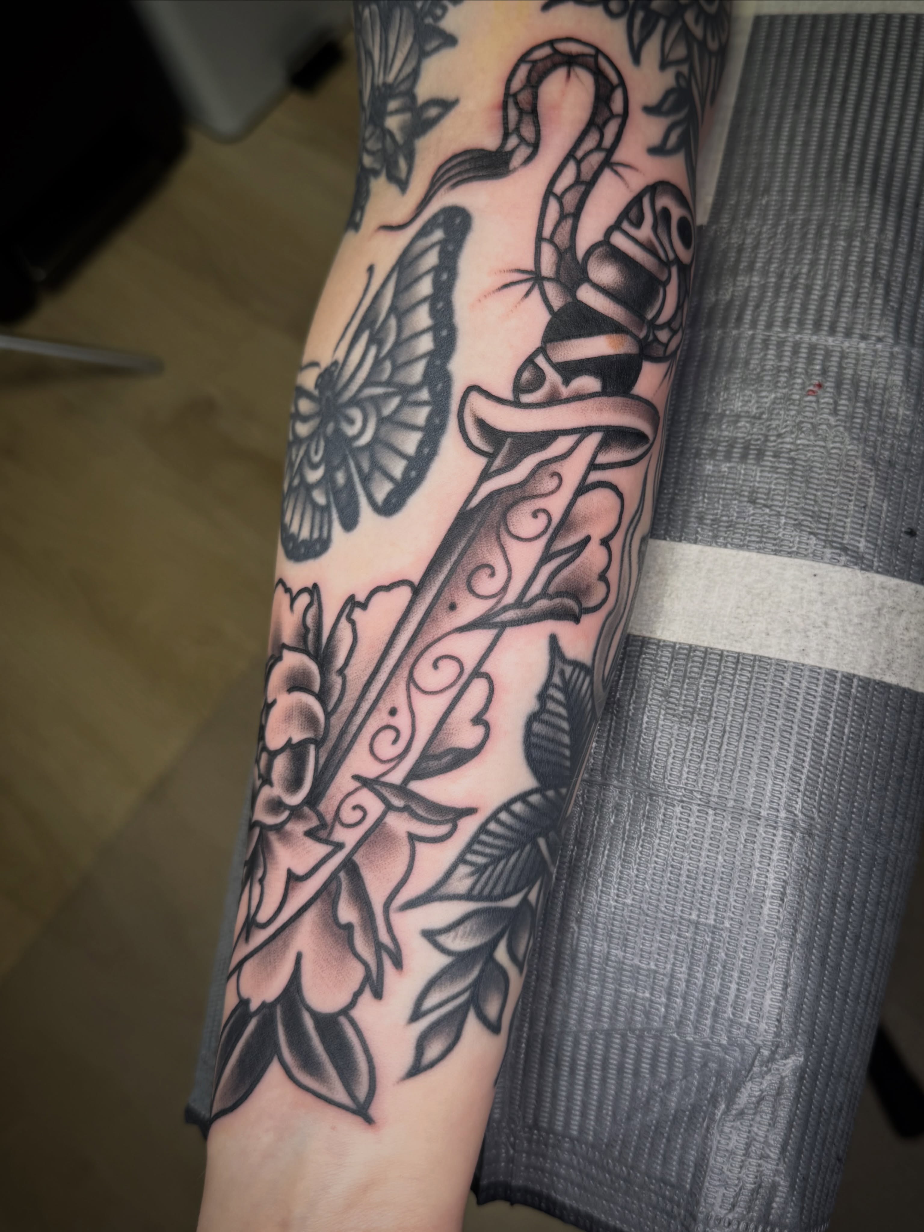 Knife and snake American traditional tattoo on the forearm by Jeremy Hudson
