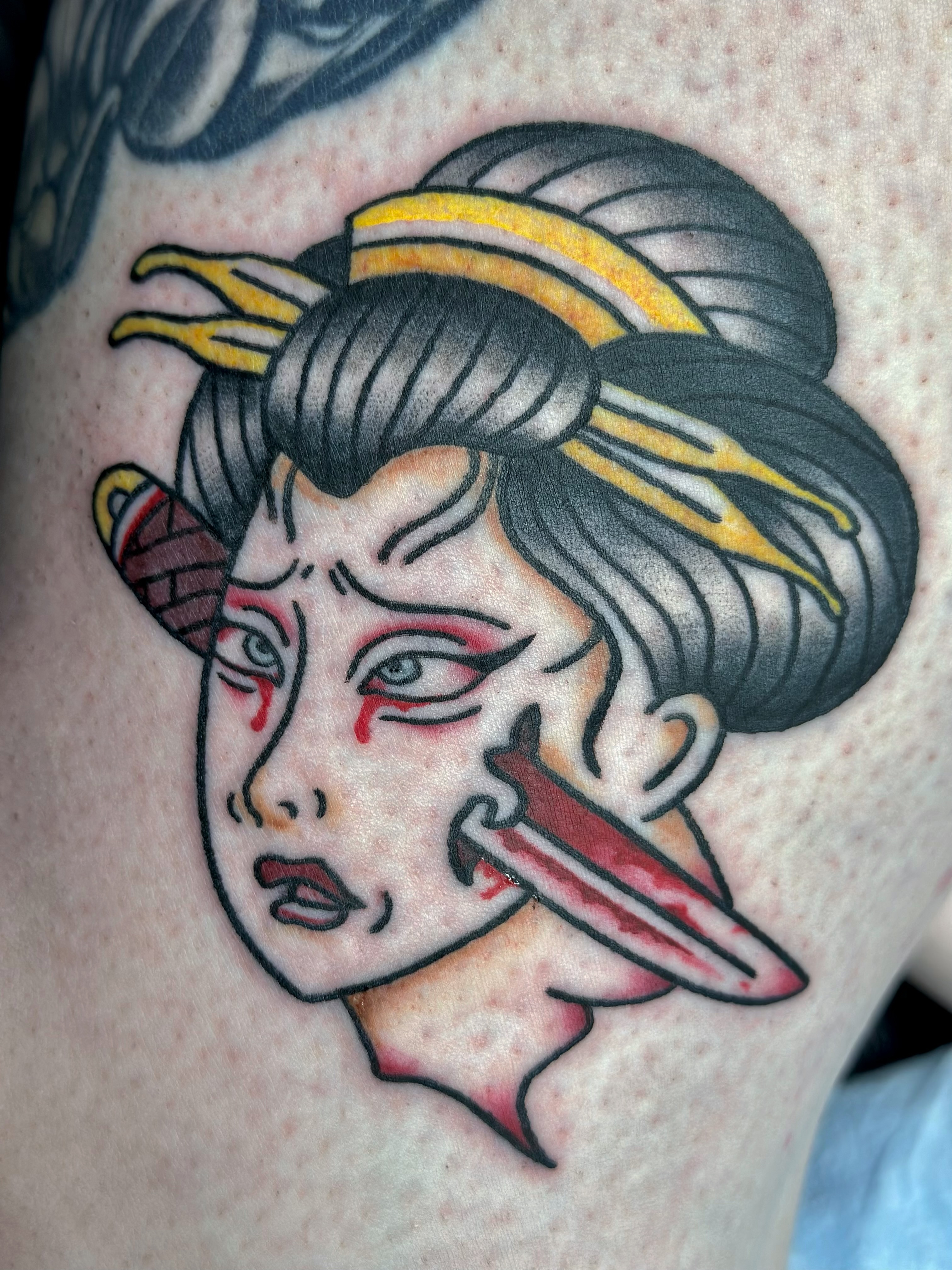 Geisha with knife American traditional tattoo on the thigh by Lucy Jay