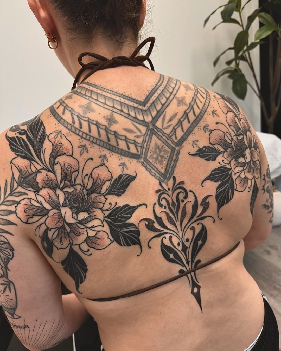 Floral and geometric ornamental tattoo on the back by Stefany