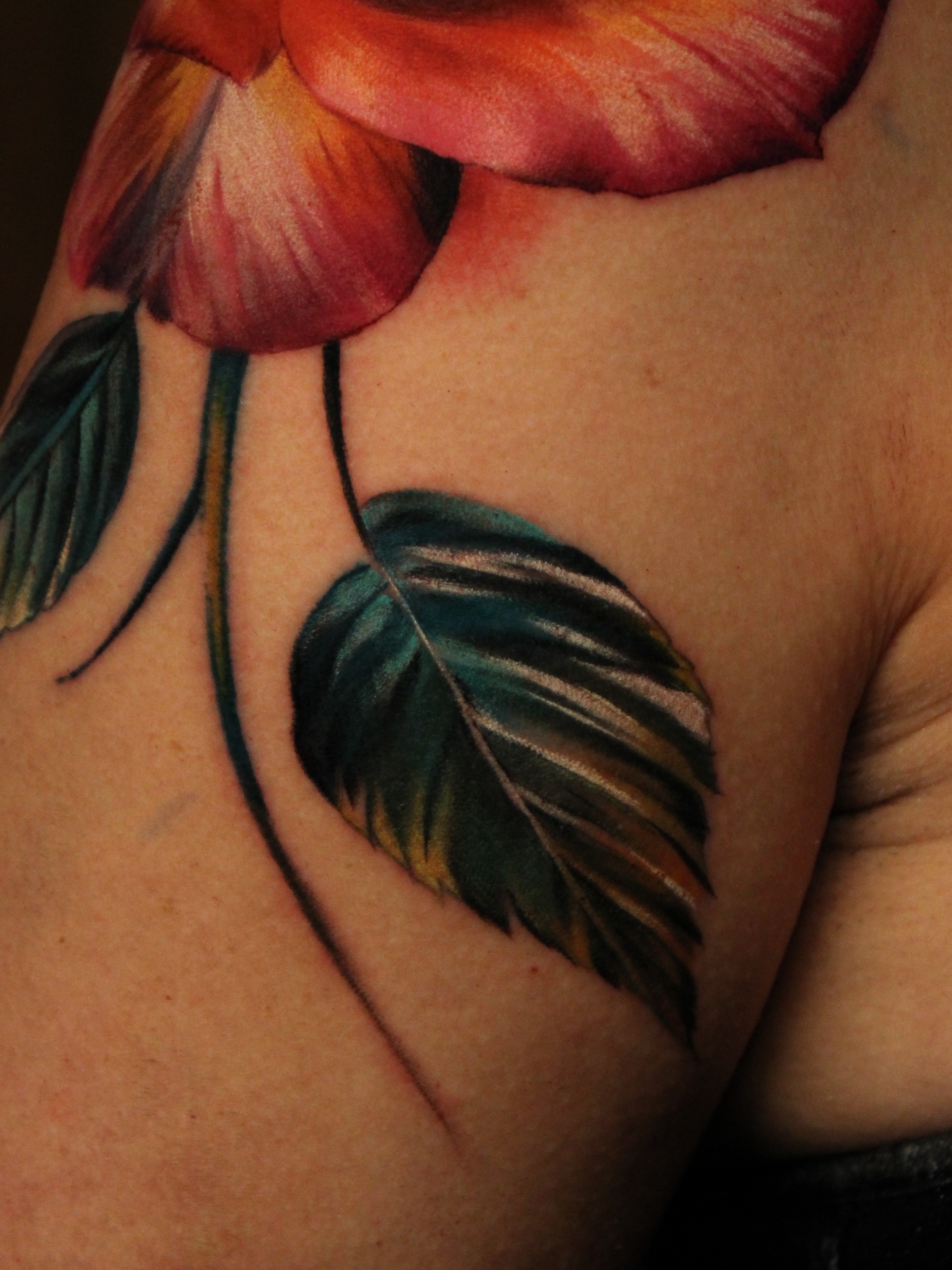 Floral realism tattoo on the shoulder by Eva Williams